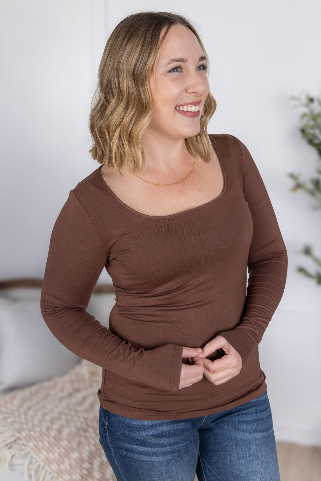 Woman wearing the Alyssa Long Sleeve Top in cocoa brown with jeans