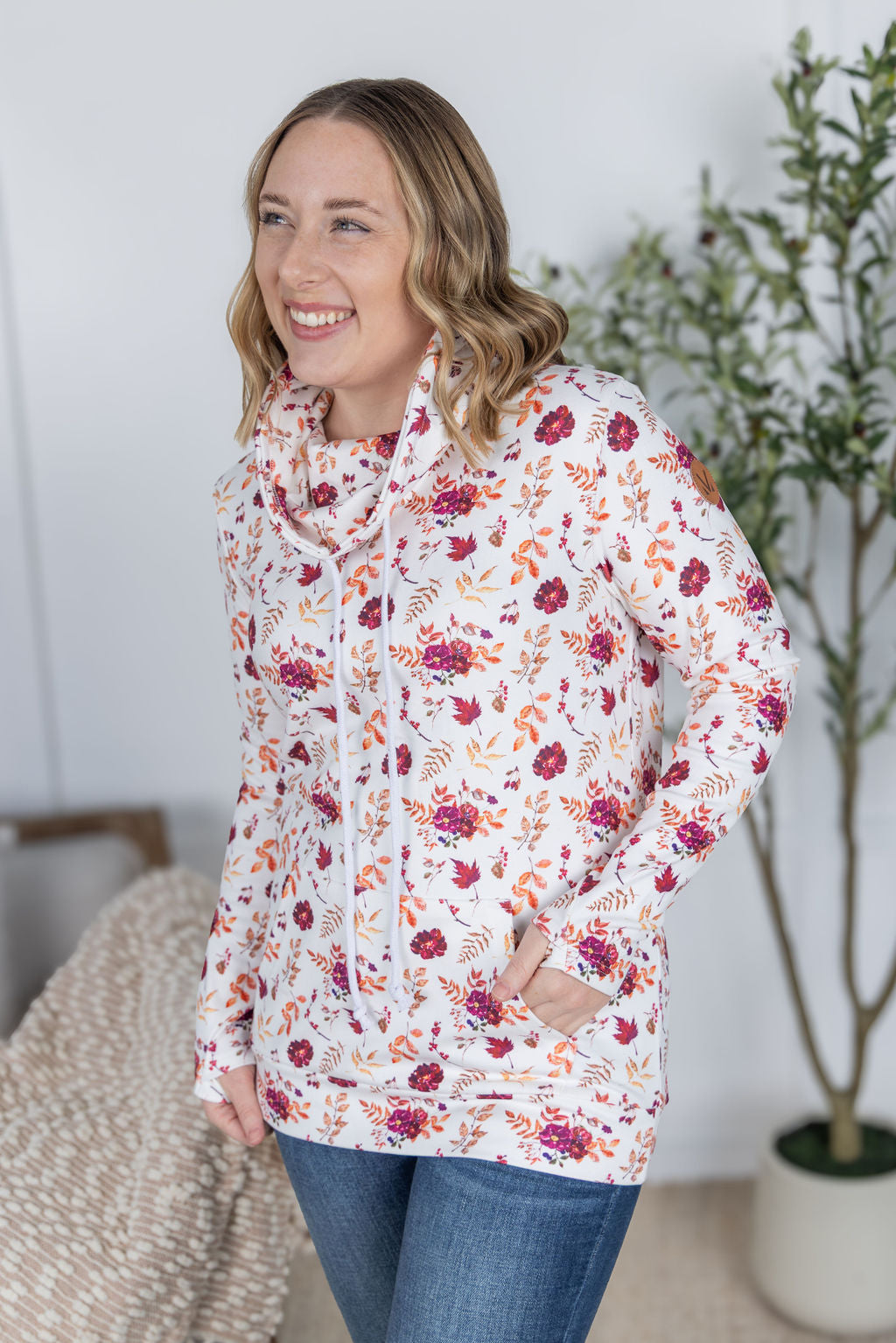 Woman wearing a soft funnel neck sweatshirt in autumn floral print
