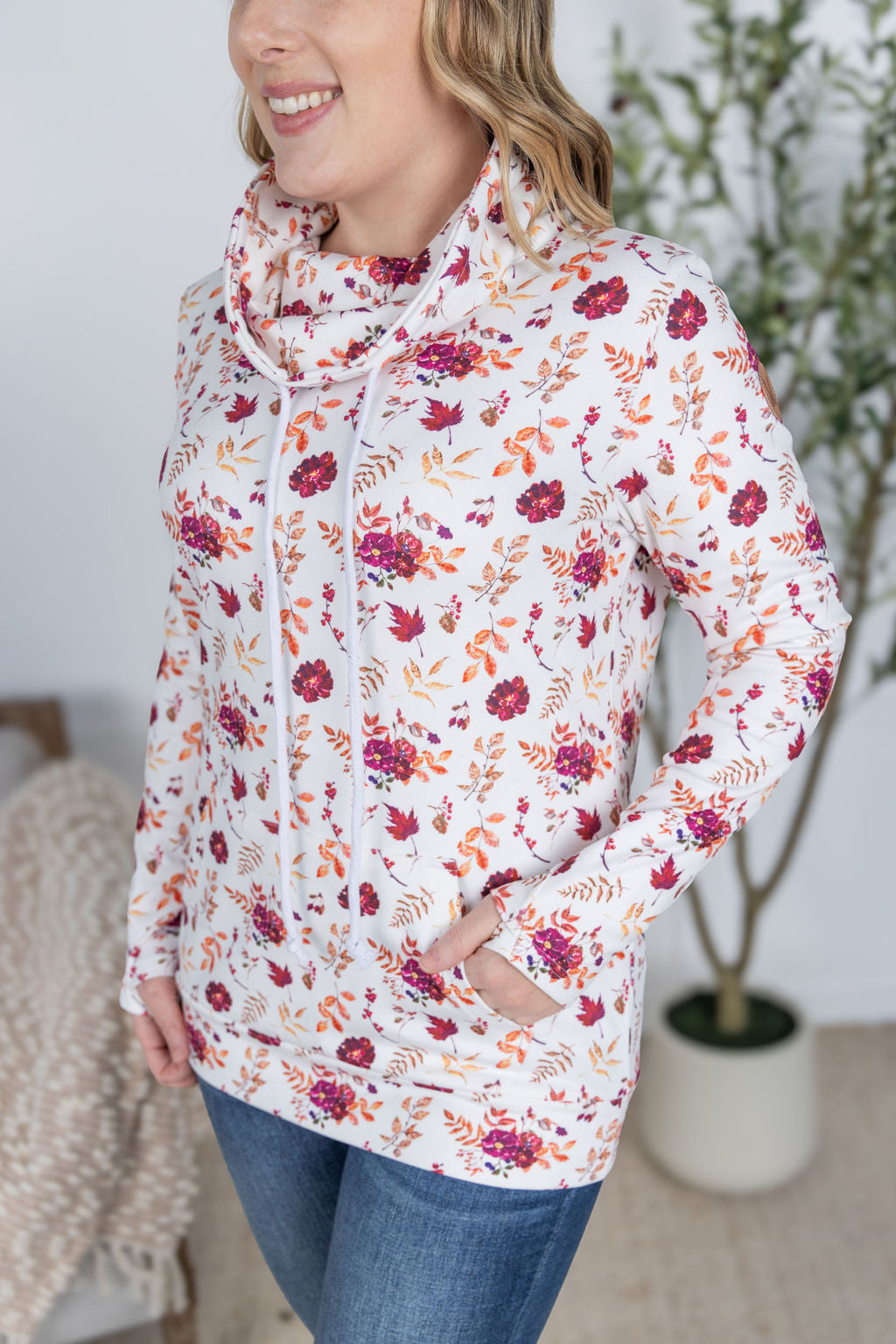 Woman wearing a soft funnel neck sweatshirt in autumn floral print