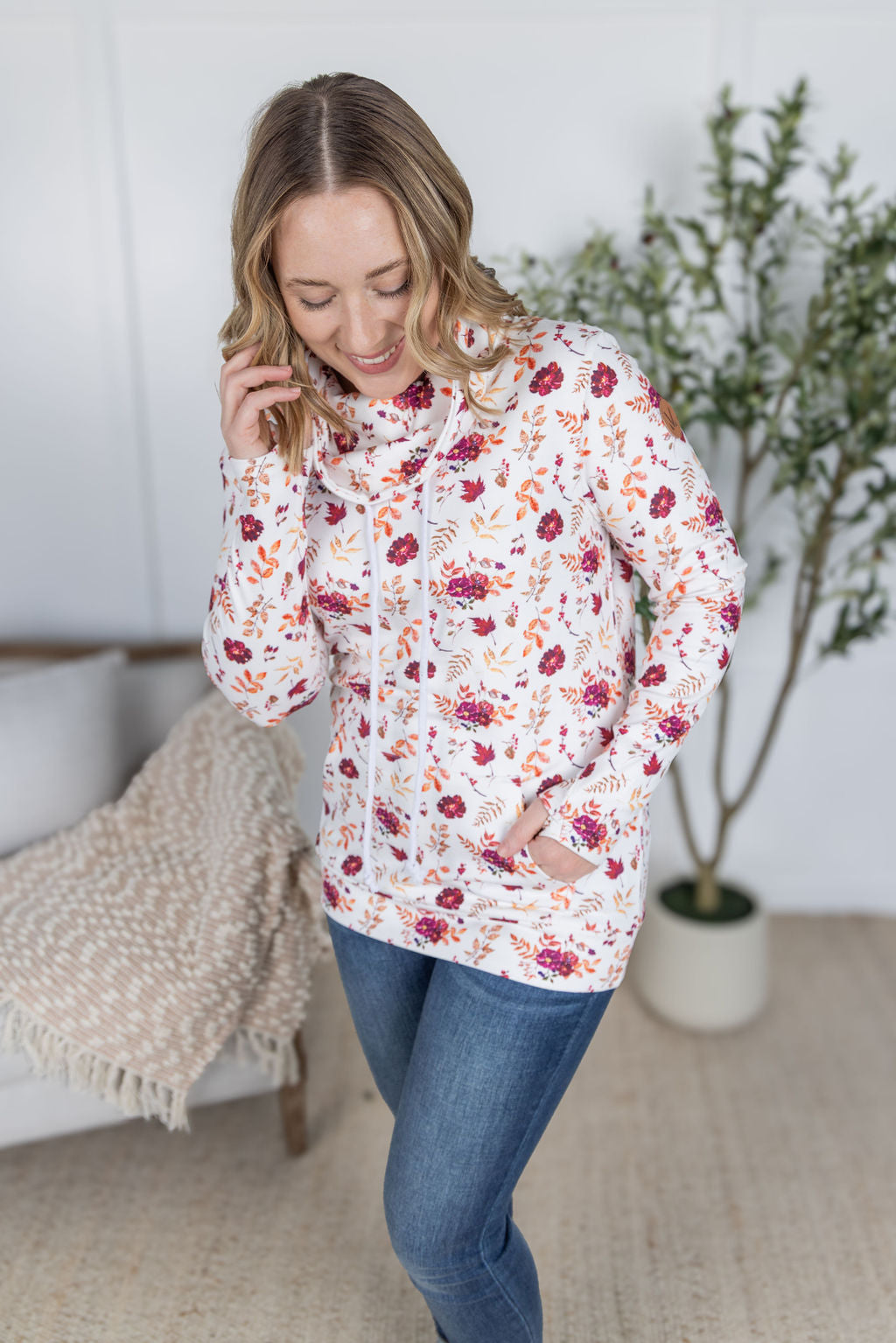 Woman wearing a soft funnel neck sweatshirt in autumn floral print