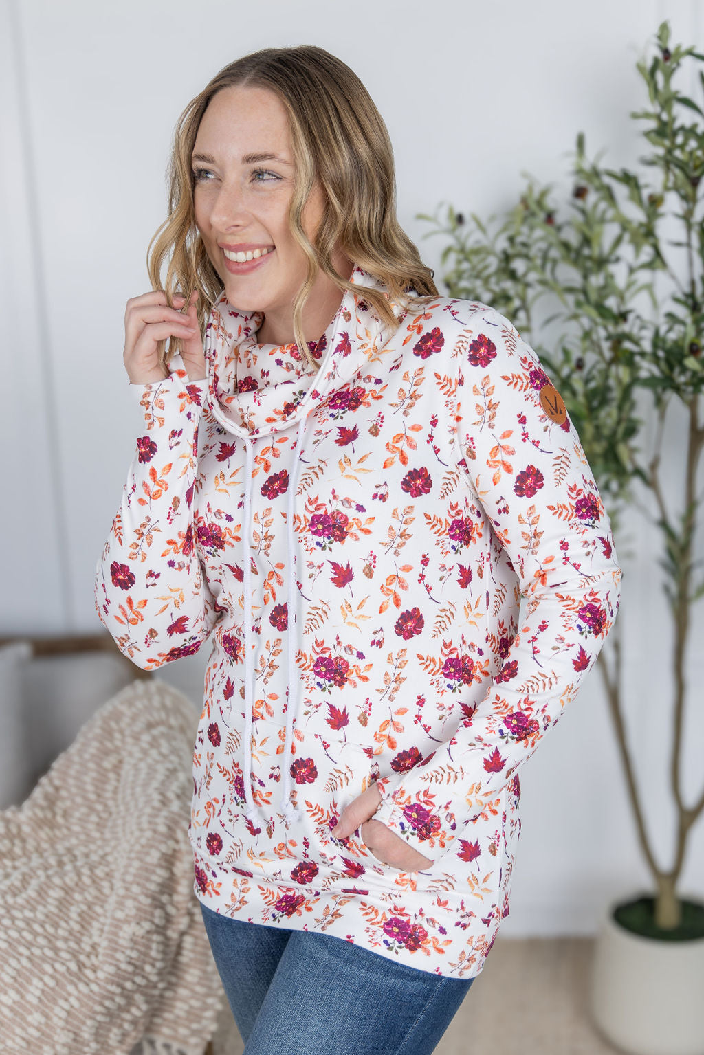 Woman wearing a soft funnel neck sweatshirt in autumn floral print