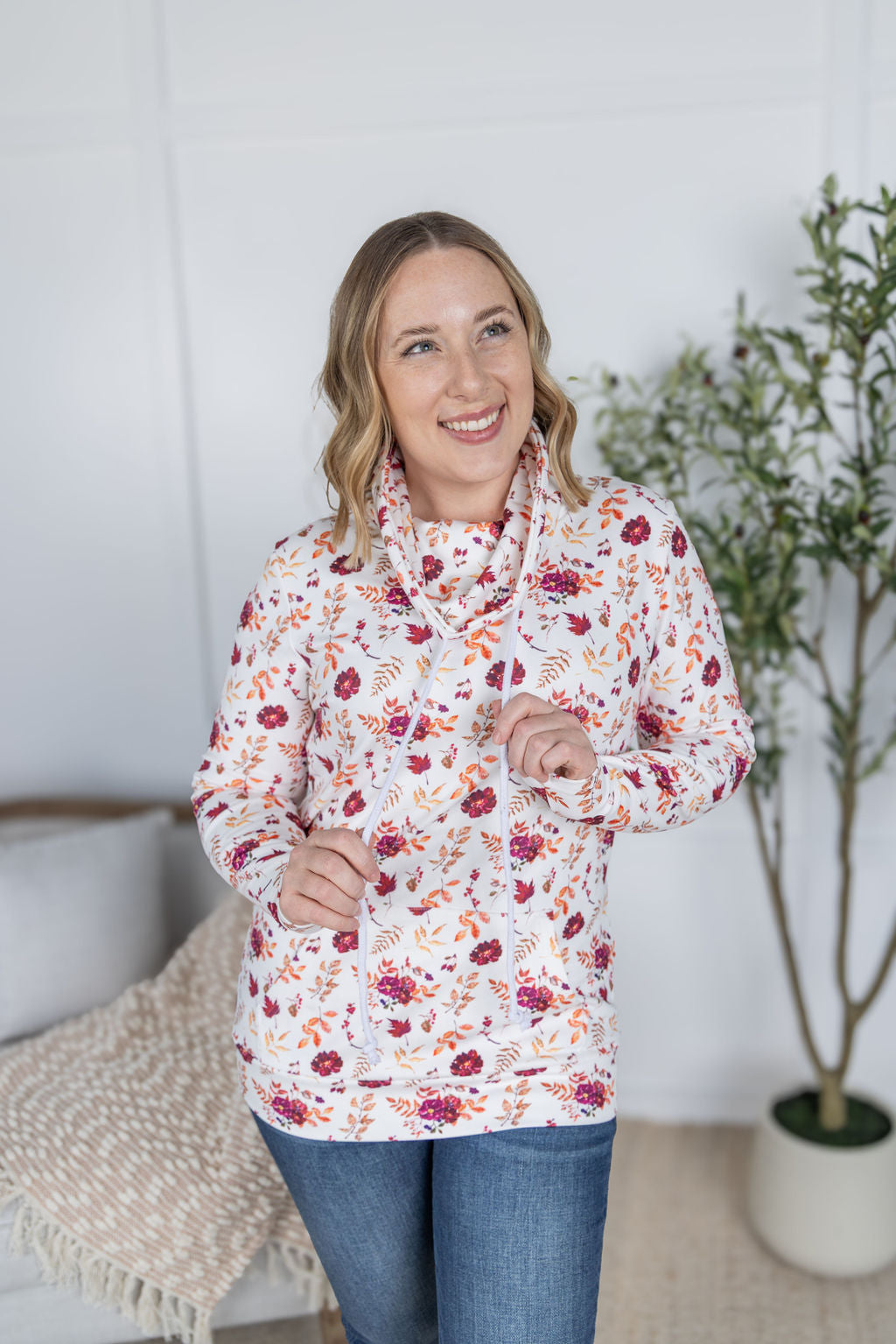 Woman wearing a soft funnel neck sweatshirt in autumn floral print