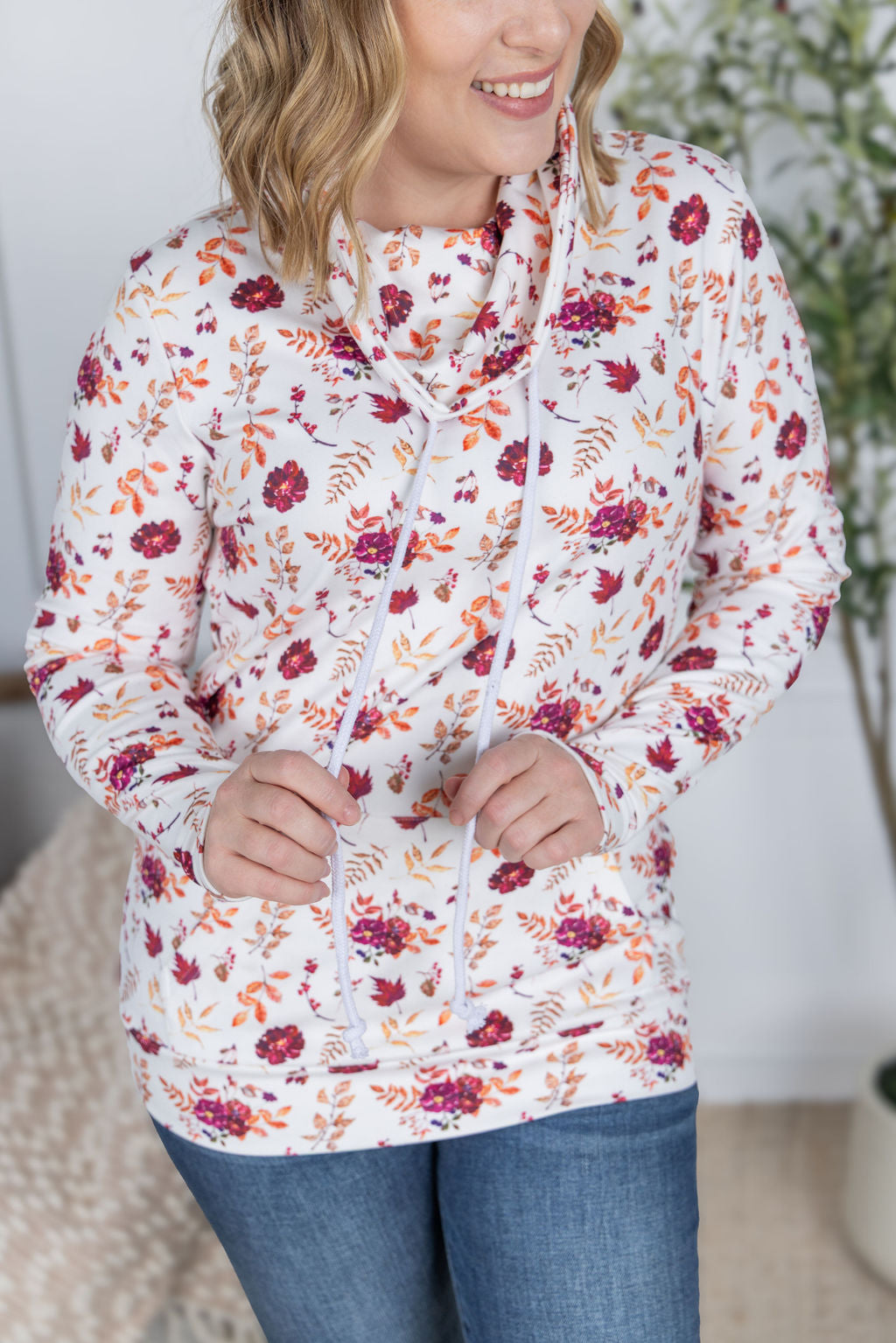 Woman wearing a soft funnel neck sweatshirt in autumn floral print