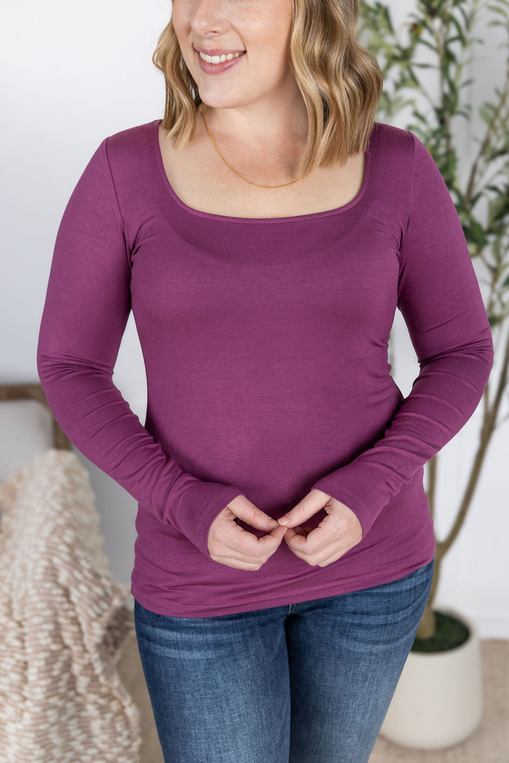 Woman wearing Alyssa Long Sleeve Top in mulberry with scoop neckline