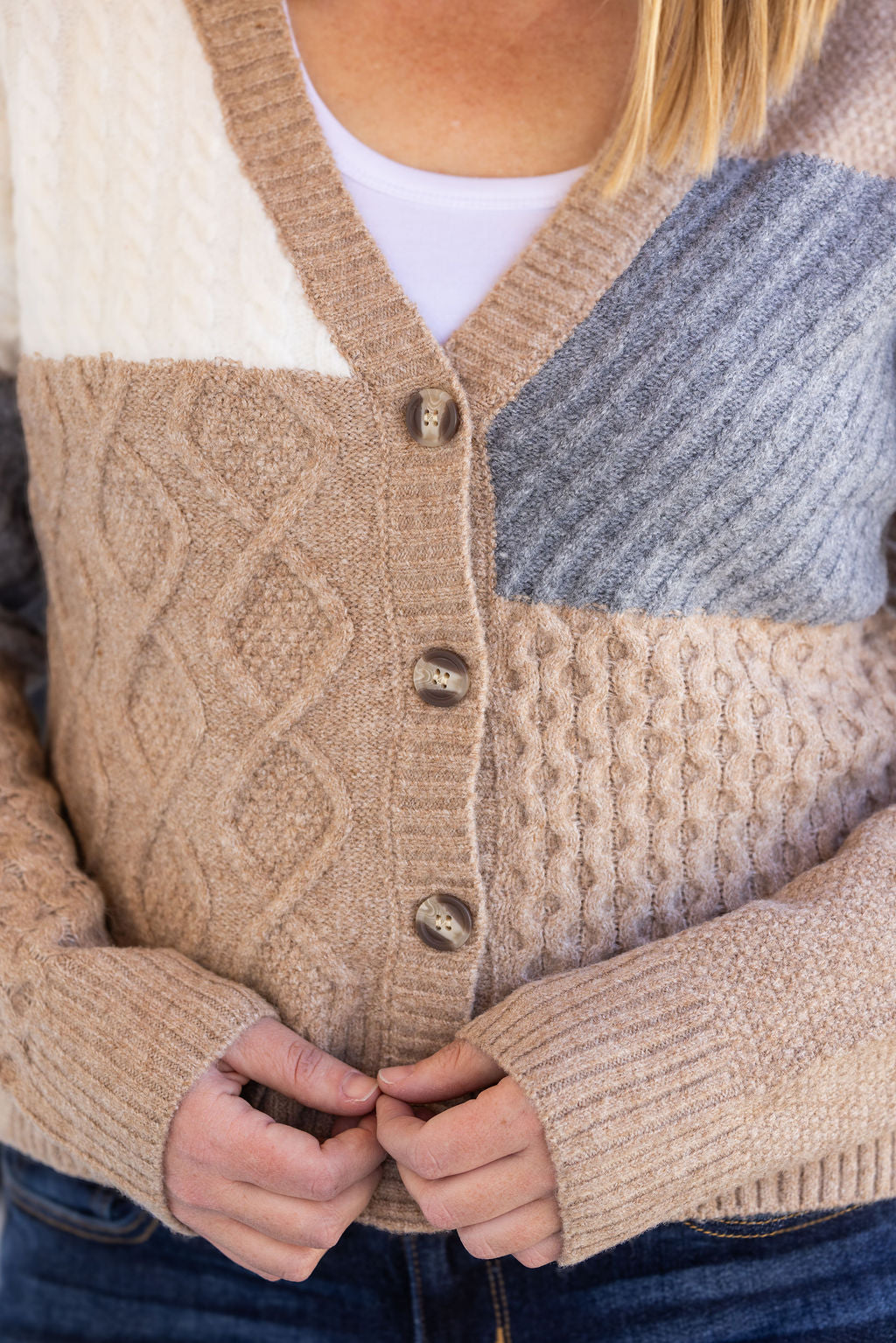 Close-up of neutral colorblock cardigan with button-up front