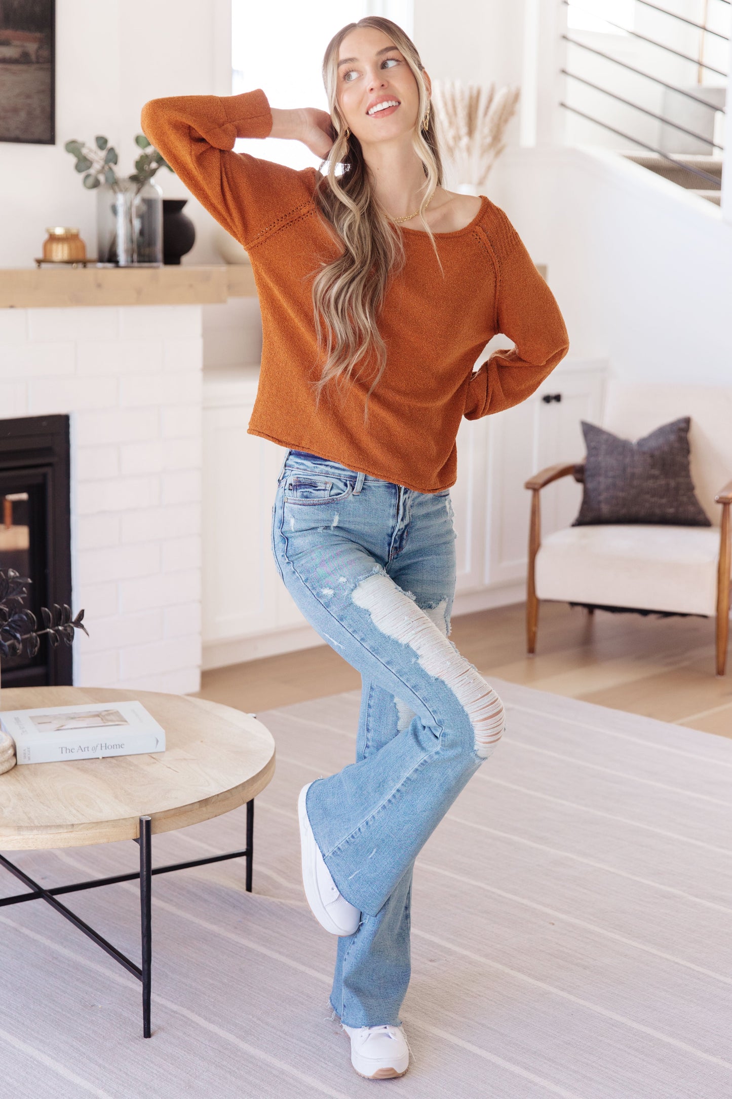Woman wearing Autumn Glow Pullover Sweater in burnt orange with raglan sleeves and exposed seams.