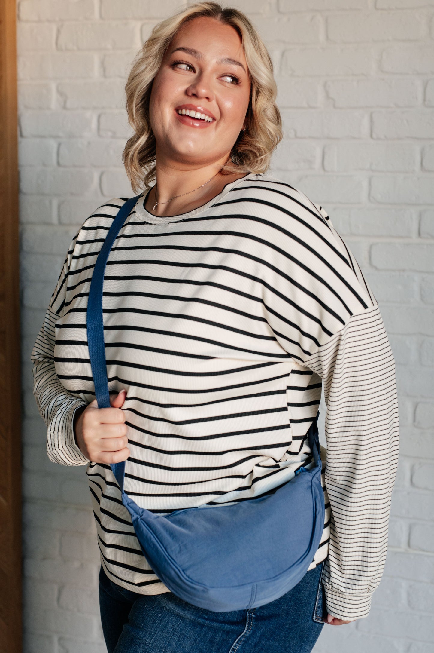 Dusty blue nylon mini crossbody bag with round dumpling shape and zipper closure