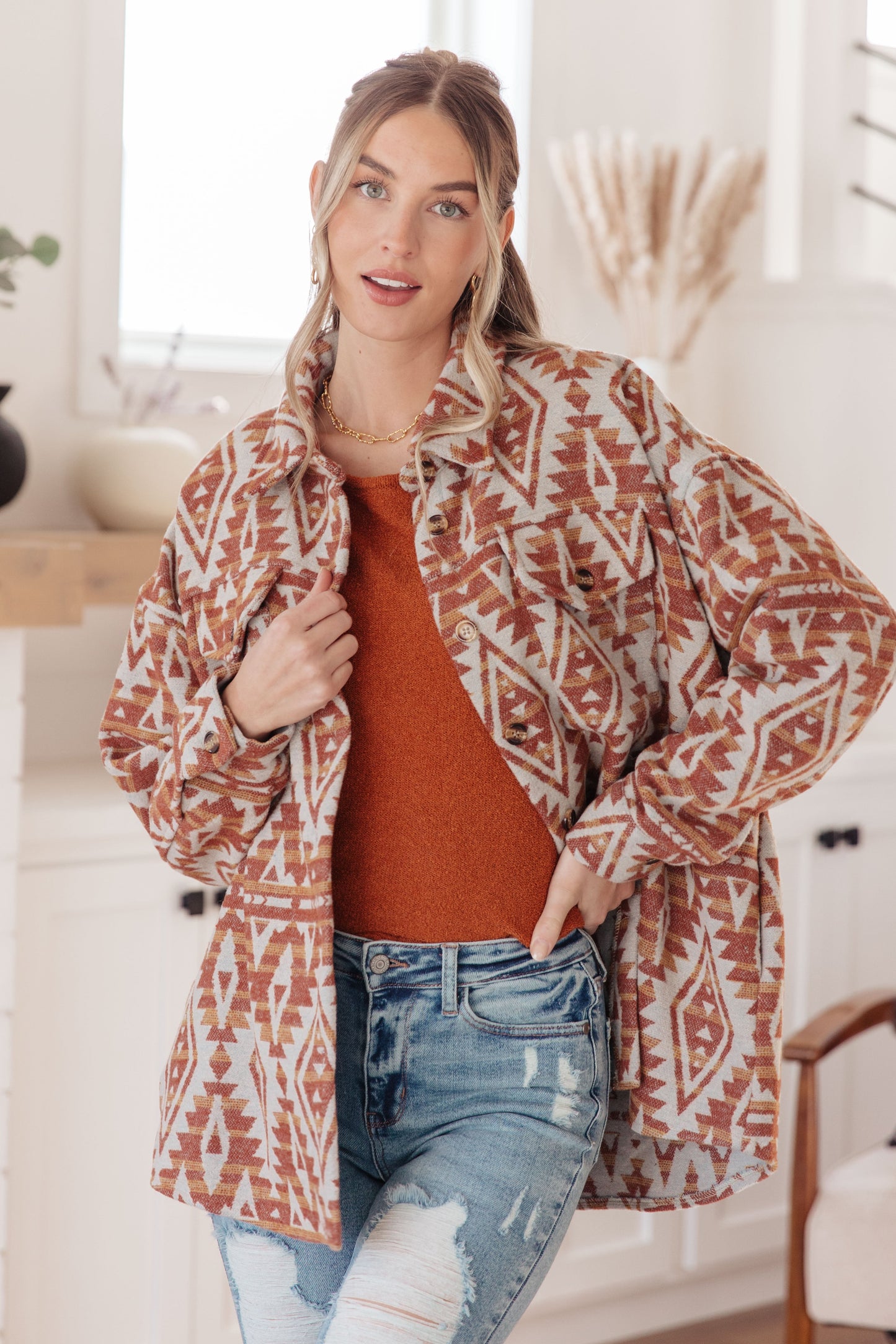 Woman wearing Autumn Glow Pullover Sweater in burnt orange with raglan sleeves and exposed seams.