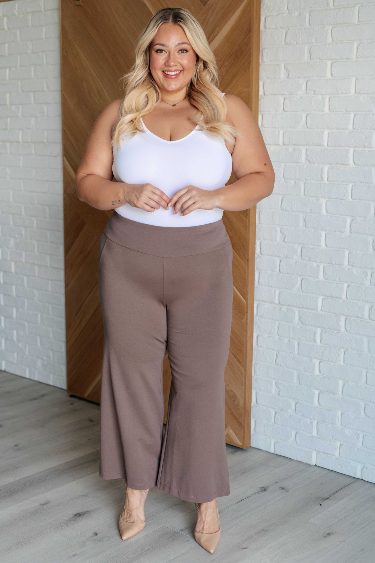 Plus size model wearing Magic Wide Leg Crop Pants in dark mocha ponte knit with cropped wide leg design and high stretch fit.