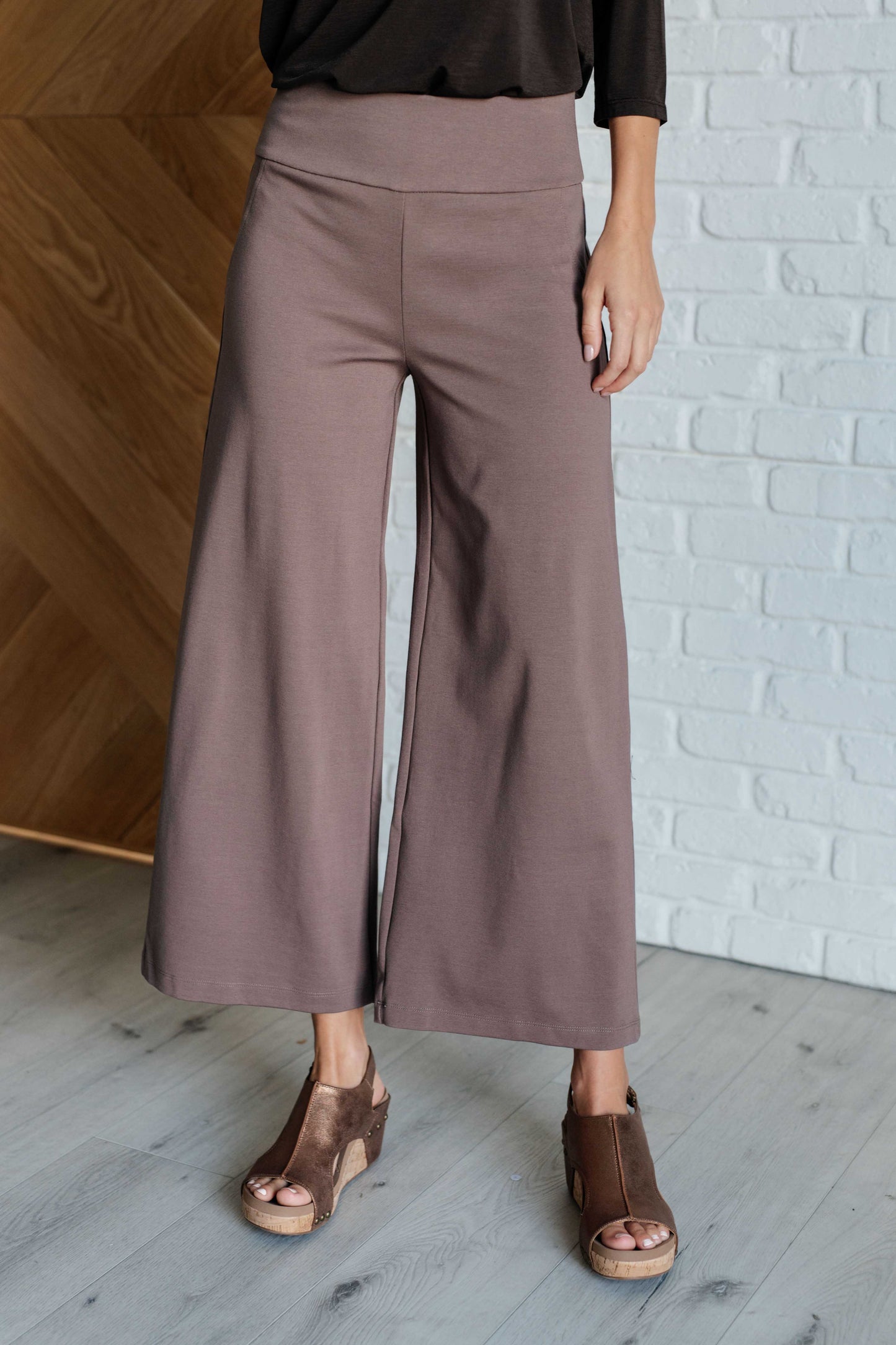 Model wearing Magic Wide Leg Crop Pants in dark mocha ponte knit with cropped wide leg design and high stretch fit.