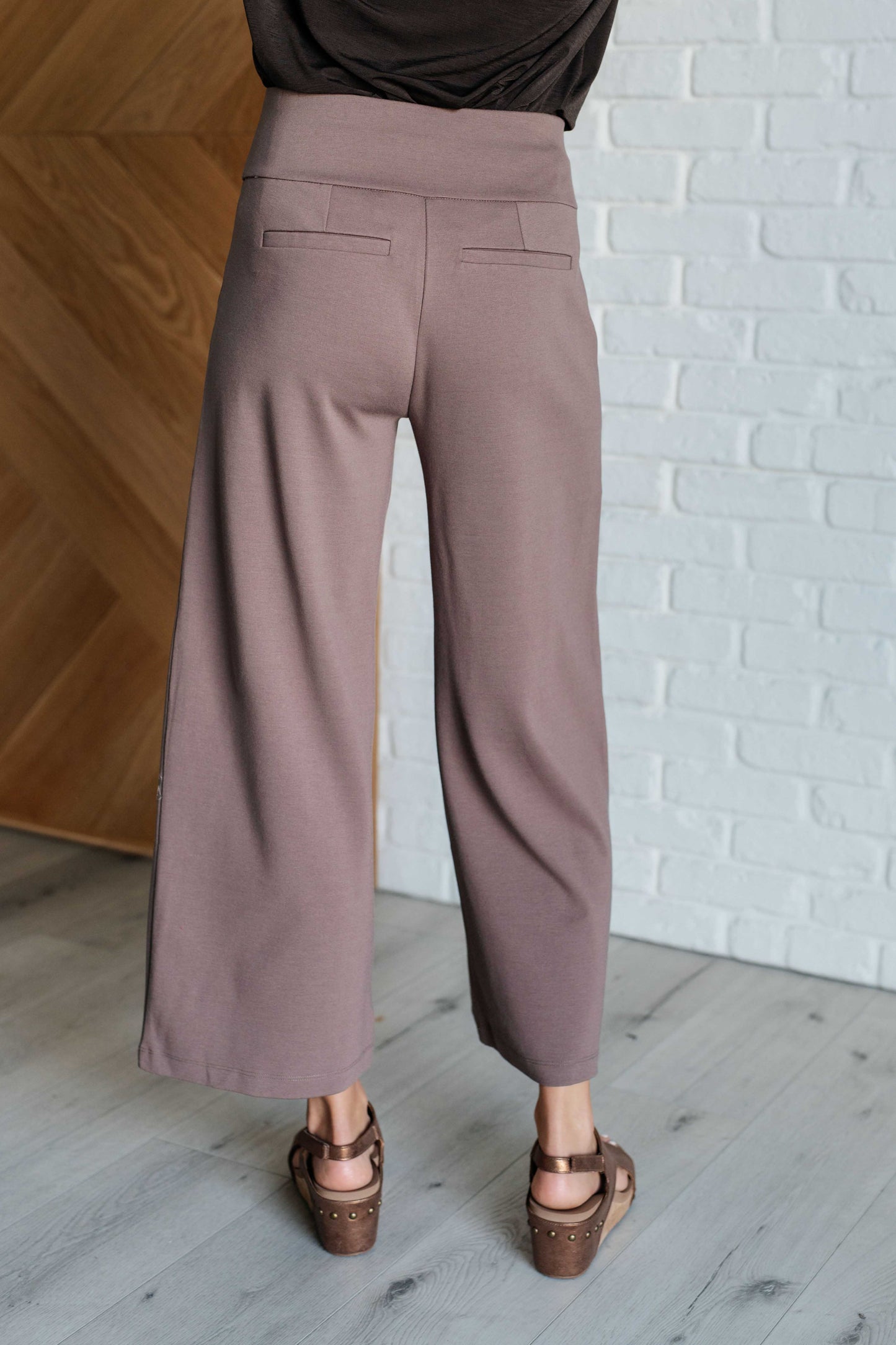 Model wearing Magic Wide Leg Crop Pants in dark mocha ponte knit with cropped wide leg design and high stretch fit.
