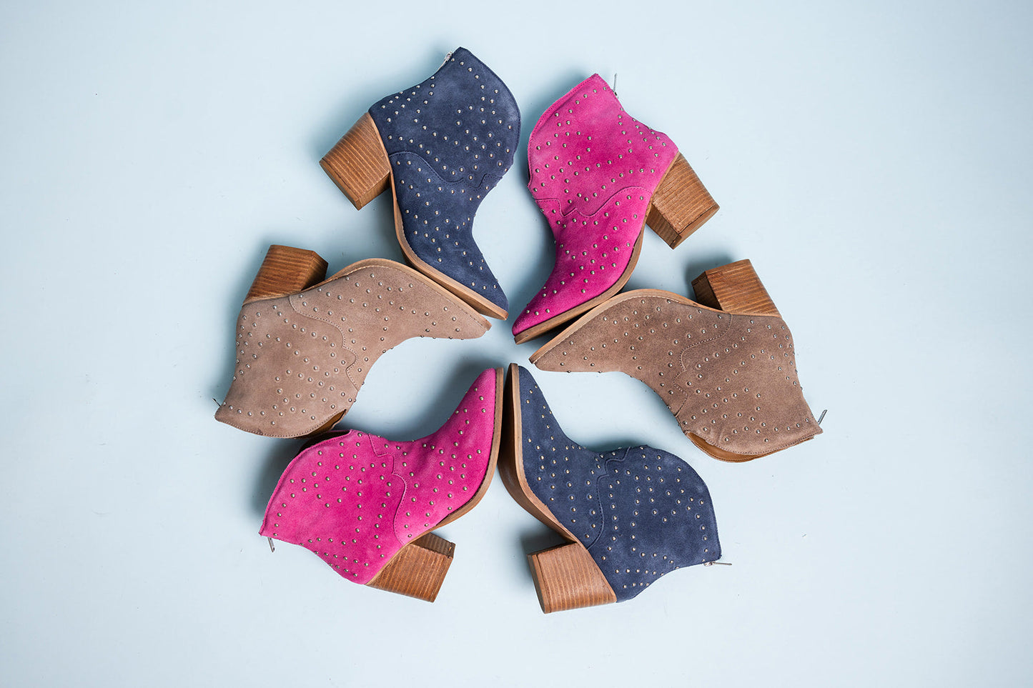 Magenta suede ankle boot with metallic studs and stacked heel