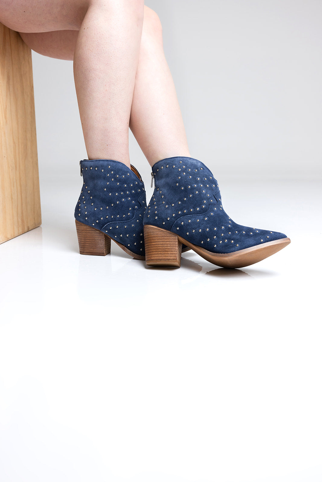 Denim blue suede ankle boot with studs and stacked heel