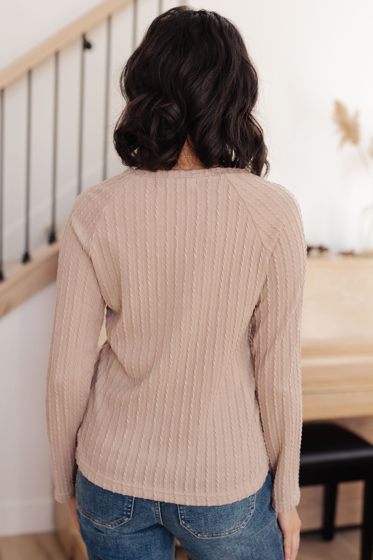 Woman wearing the Winding Down Cable Detail Top in soft textured knit with raglan sleeves.