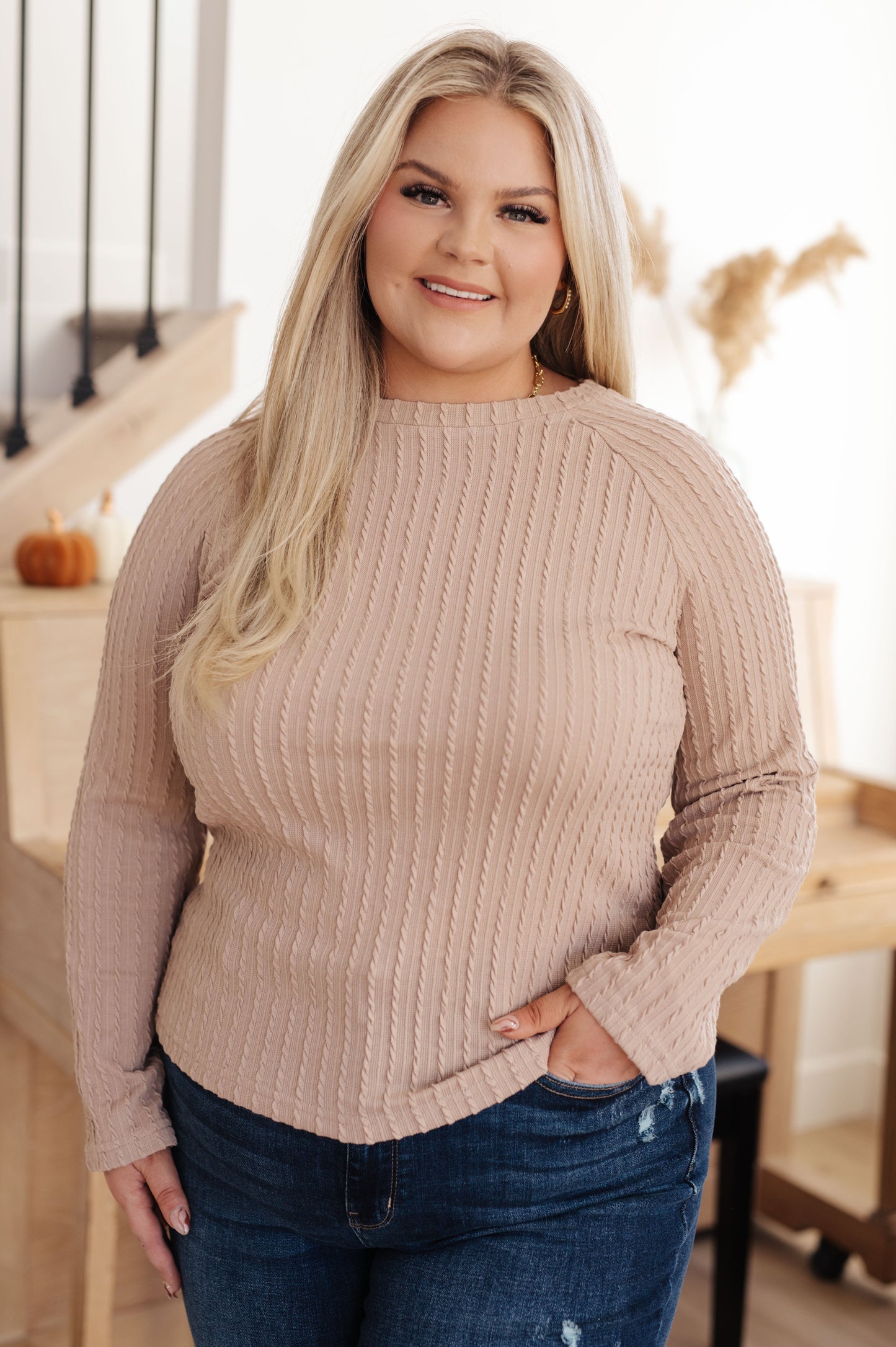 Woman wearing the Winding Down Cable Detail Top in soft textured knit with raglan sleeves.