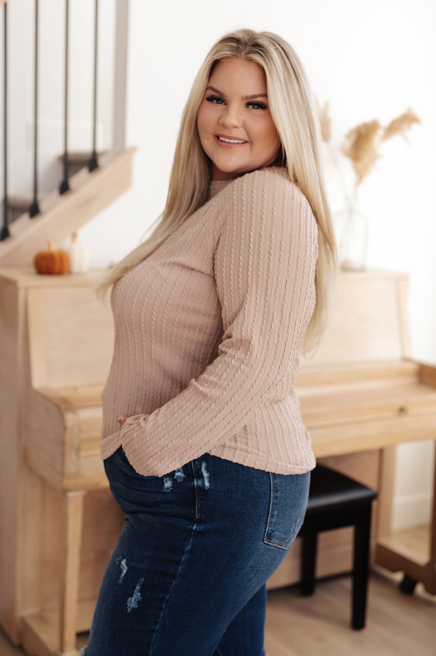 Woman wearing the Winding Down Cable Detail Top in soft textured knit with raglan sleeves.