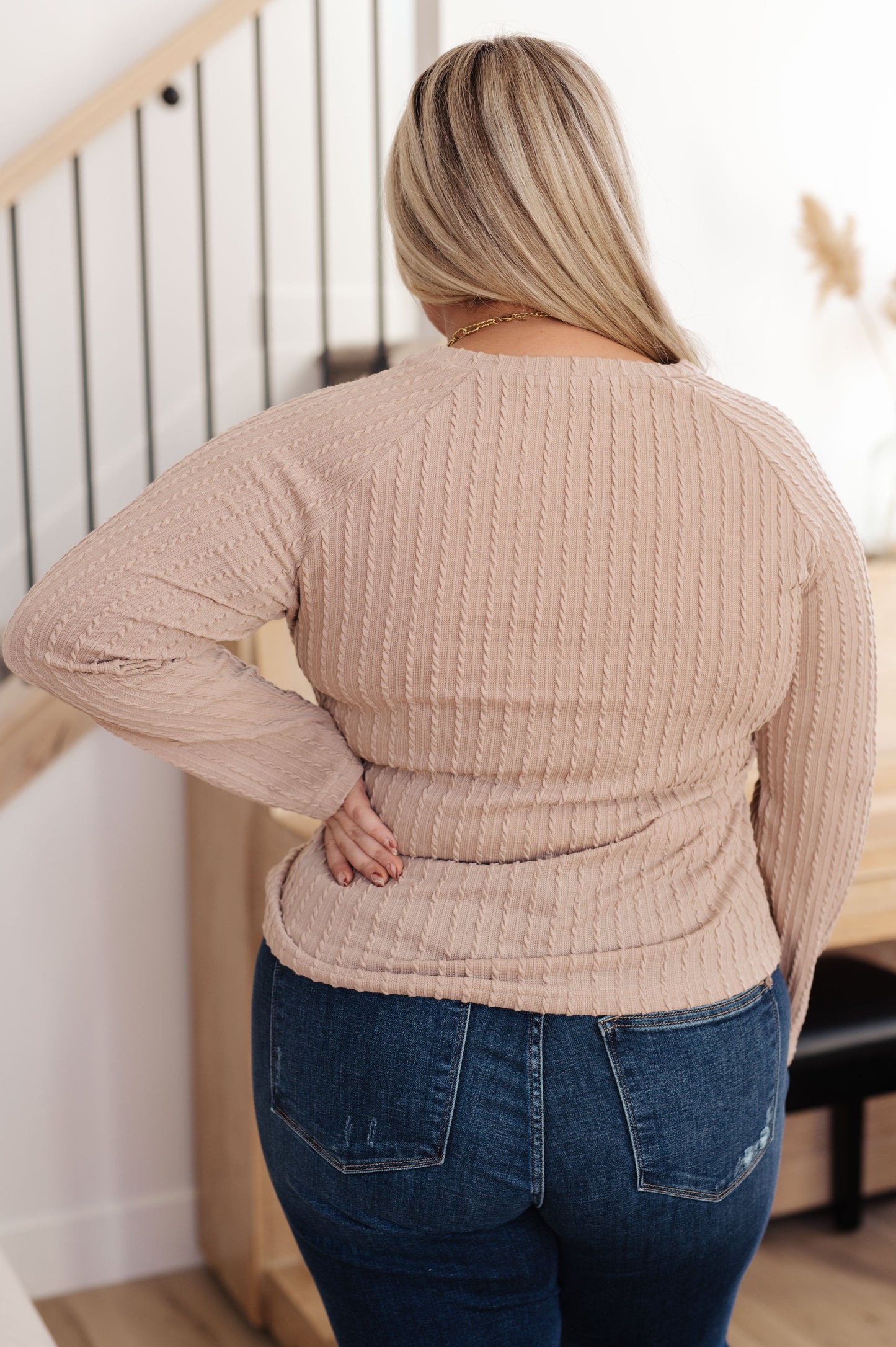 Woman wearing the Winding Down Cable Detail Top in soft textured knit with raglan sleeves.
