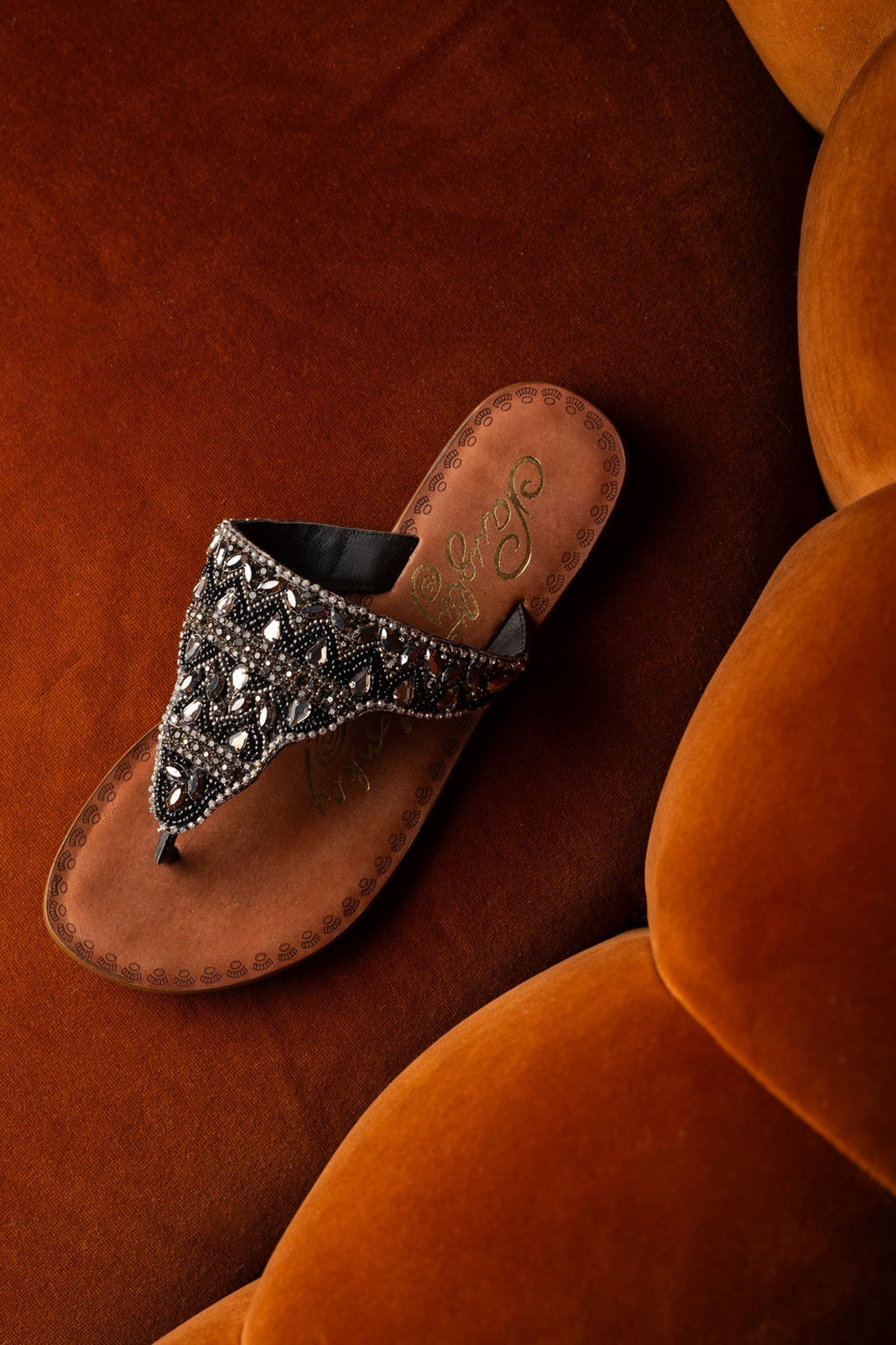 Black jeweled sandals with genuine leather footbed and ornate beaded design