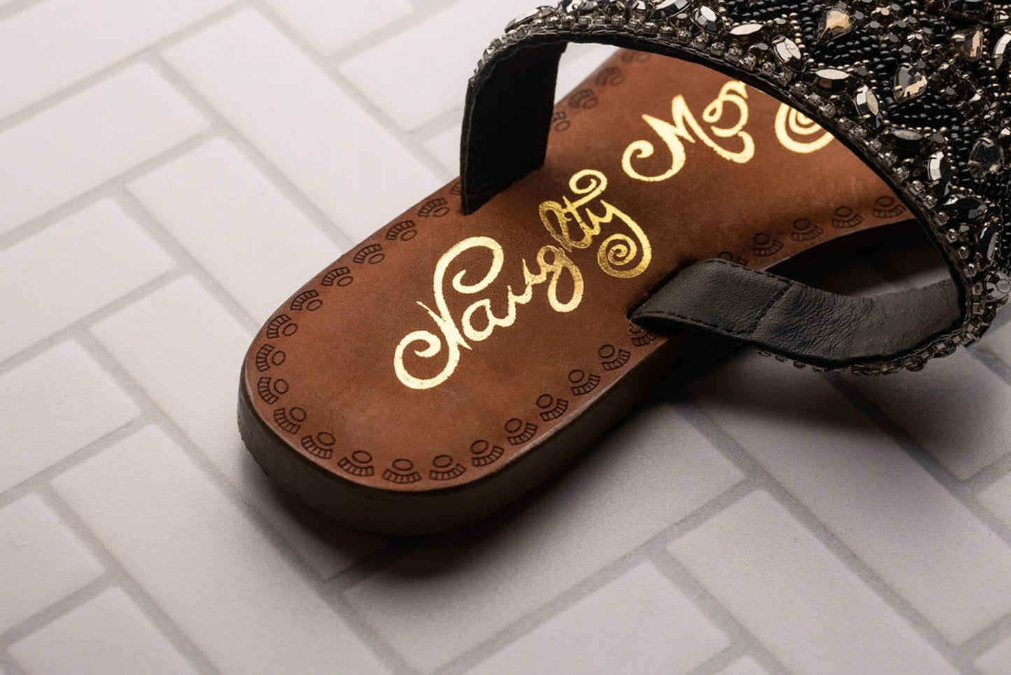 Black jeweled sandals with genuine leather footbed and ornate beaded design