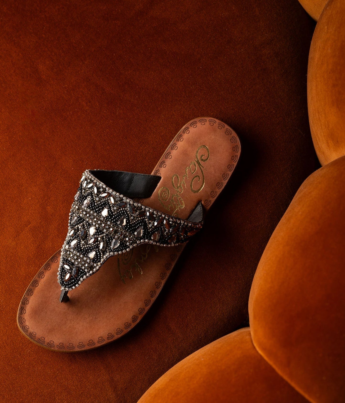Black jeweled sandals with genuine leather footbed and ornate beaded design