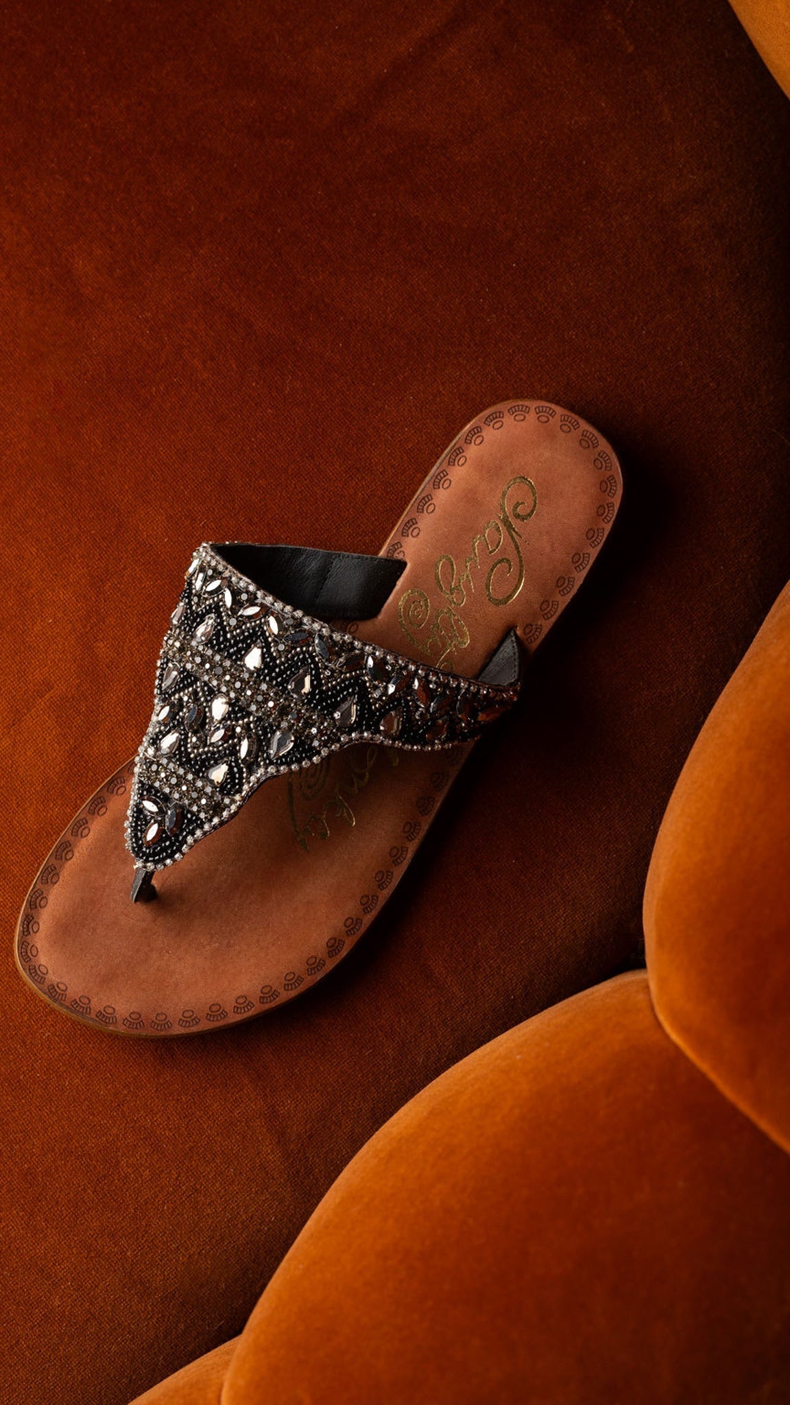 Black jeweled sandals with genuine leather footbed and ornate beaded design