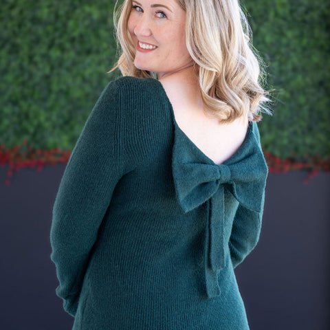 Stylish woman in a black striped dress with ruffled sleeves, perfect for summer occasions at Ruthie's Rack.