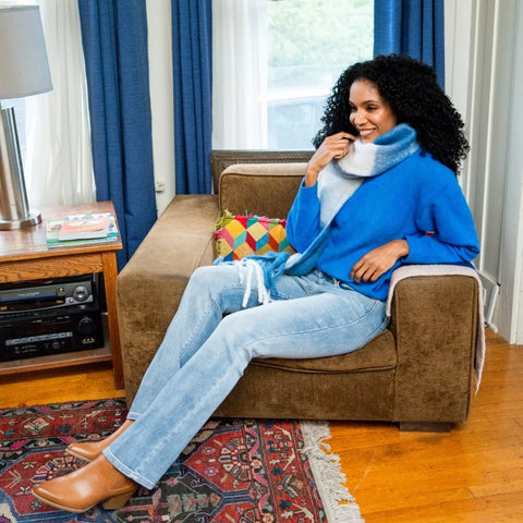 Woman wearing stylish Judy Blue cropped jeans paired with sandals in a modern interior setting.