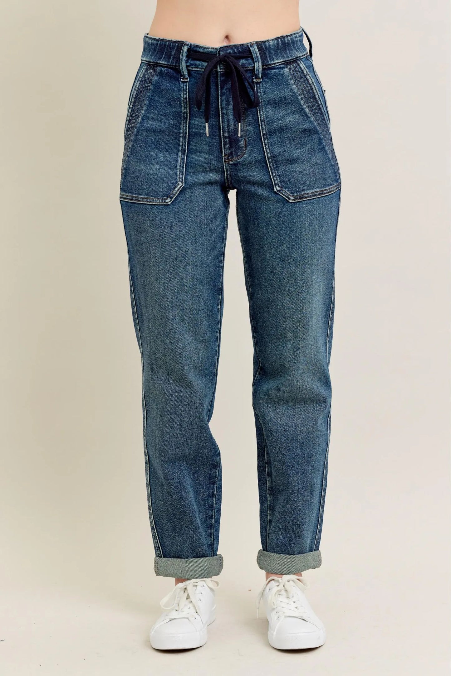 Woman wearing Adler vintage wash high waisted utility jeans with drawstring waist and front patch pockets