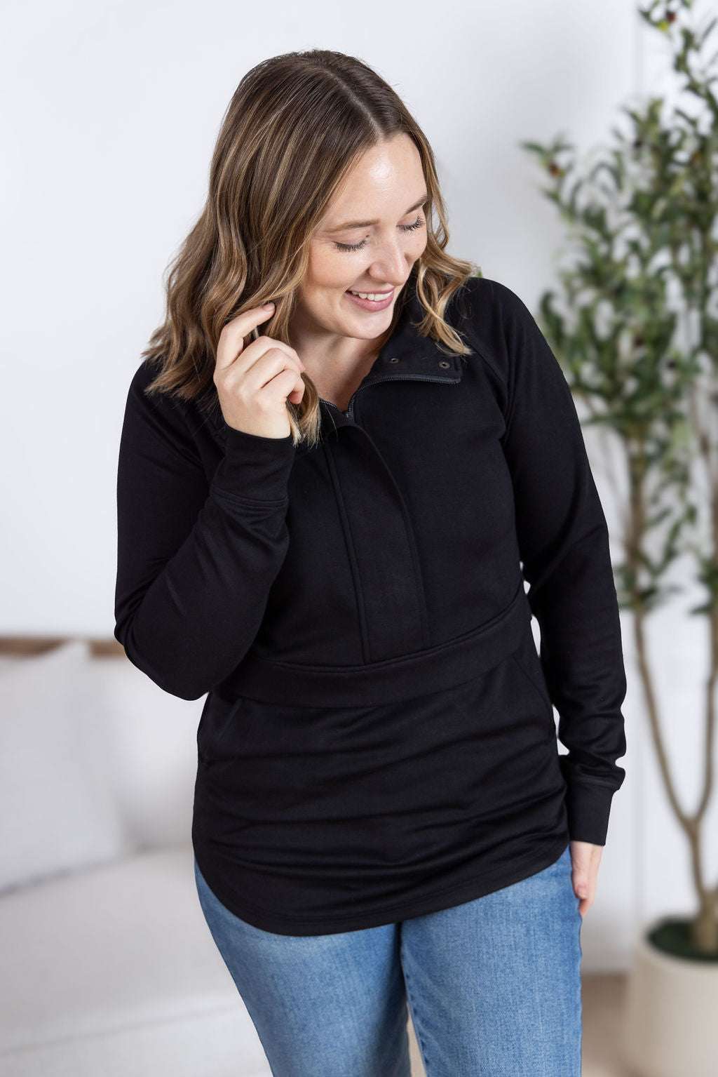 Model wearing the Mia Scuba Halfzip Pullover with curved hem and snap button collar