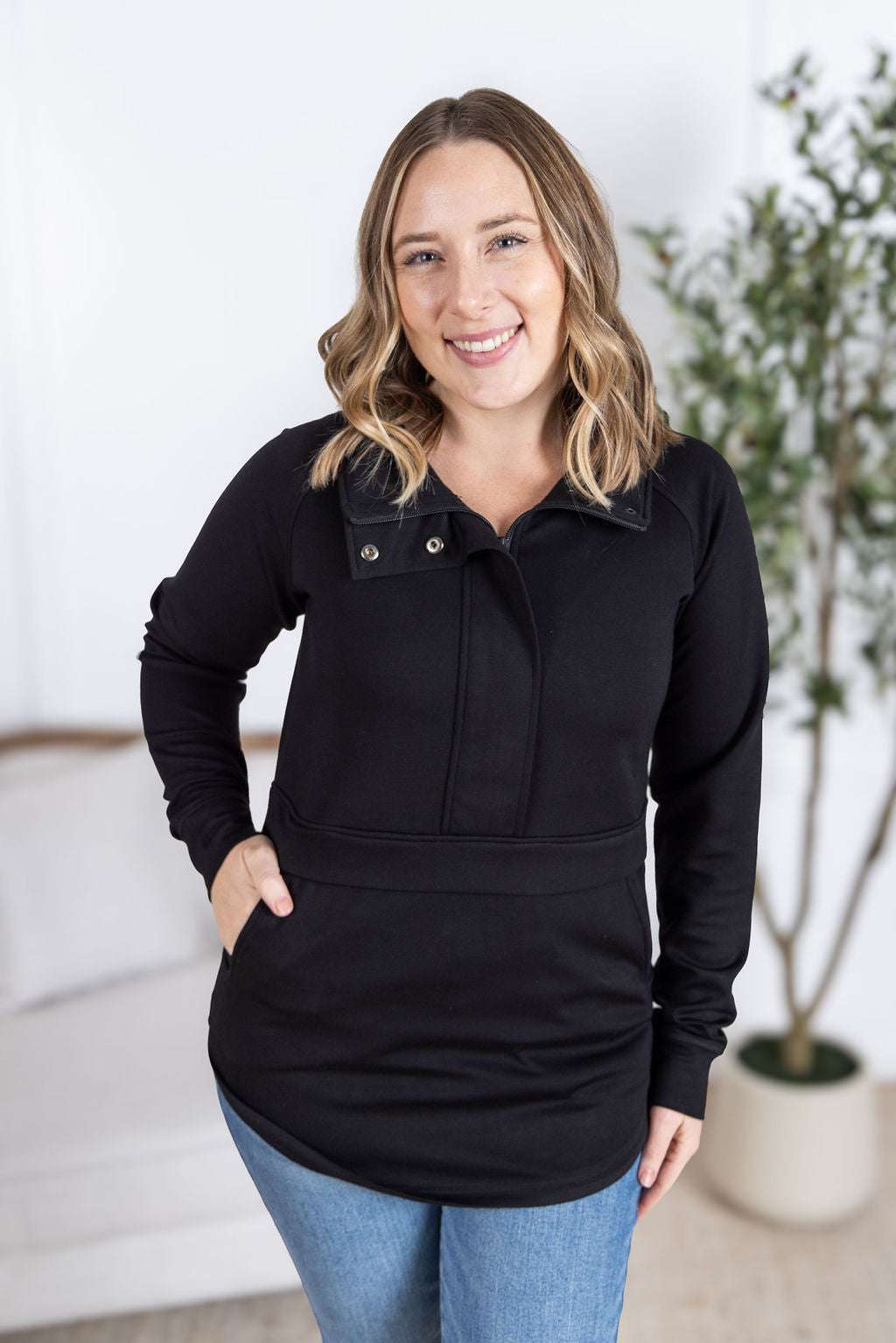 Model wearing the Mia Scuba Halfzip Pullover with curved hem and snap button collar