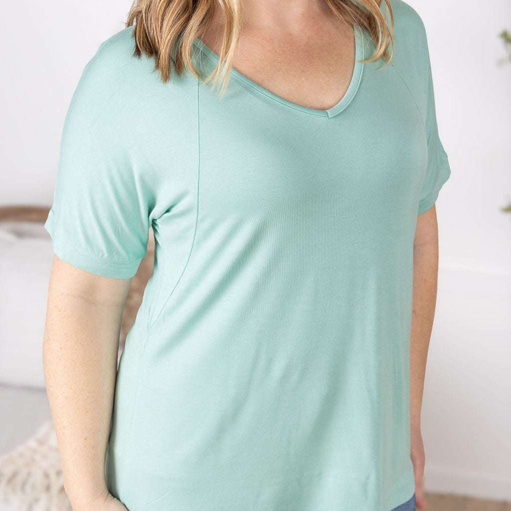 Close-up of a smiling model wearing the Bamboo V Neck Tee in mint by Michelle Mae, featuring a flattering v-neckline, short sleeves, and comfortable relaxed fit