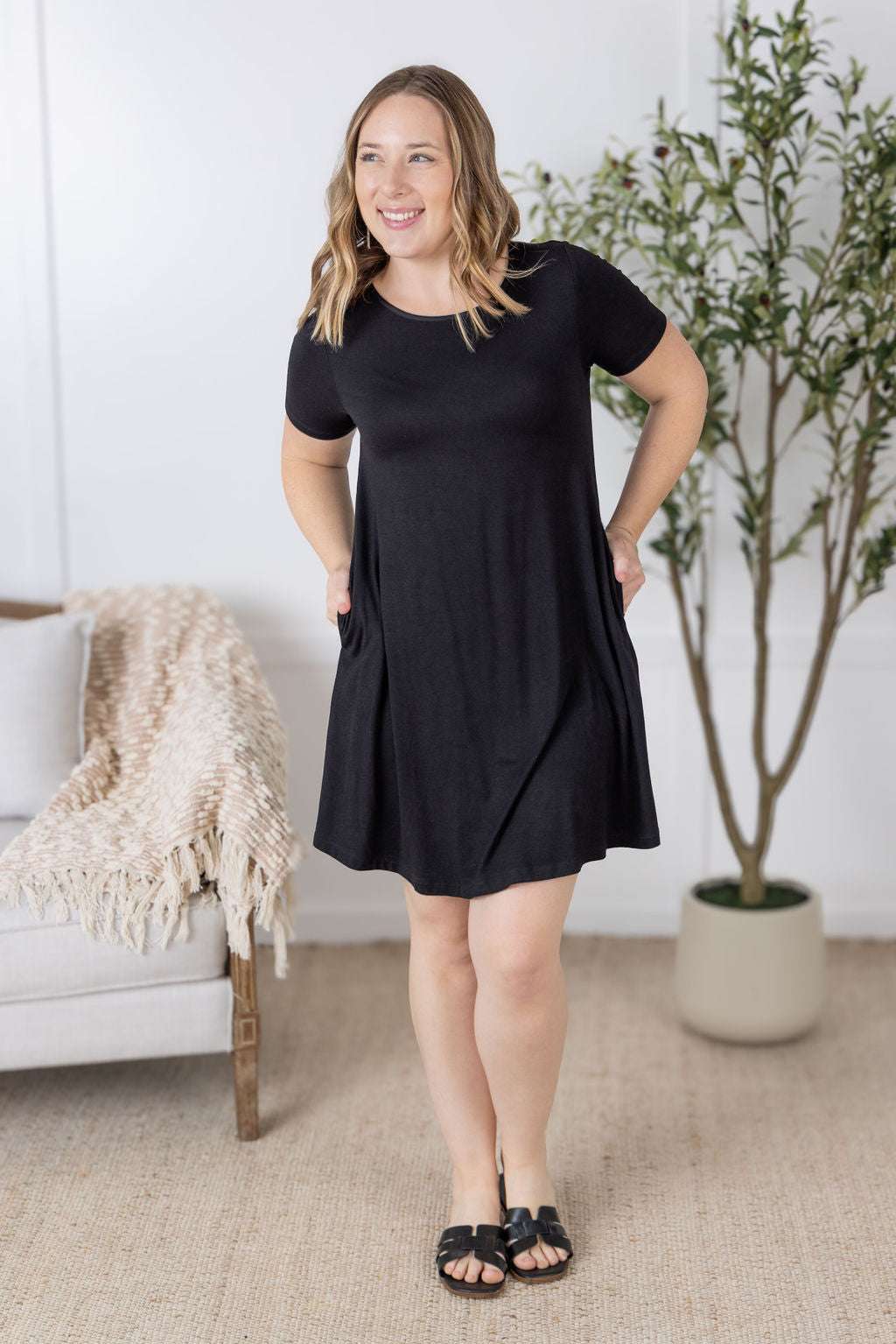 Model wearing the Roxy Swing Tunic Dress in a relaxed swing silhouette with short sleeves and side pockets