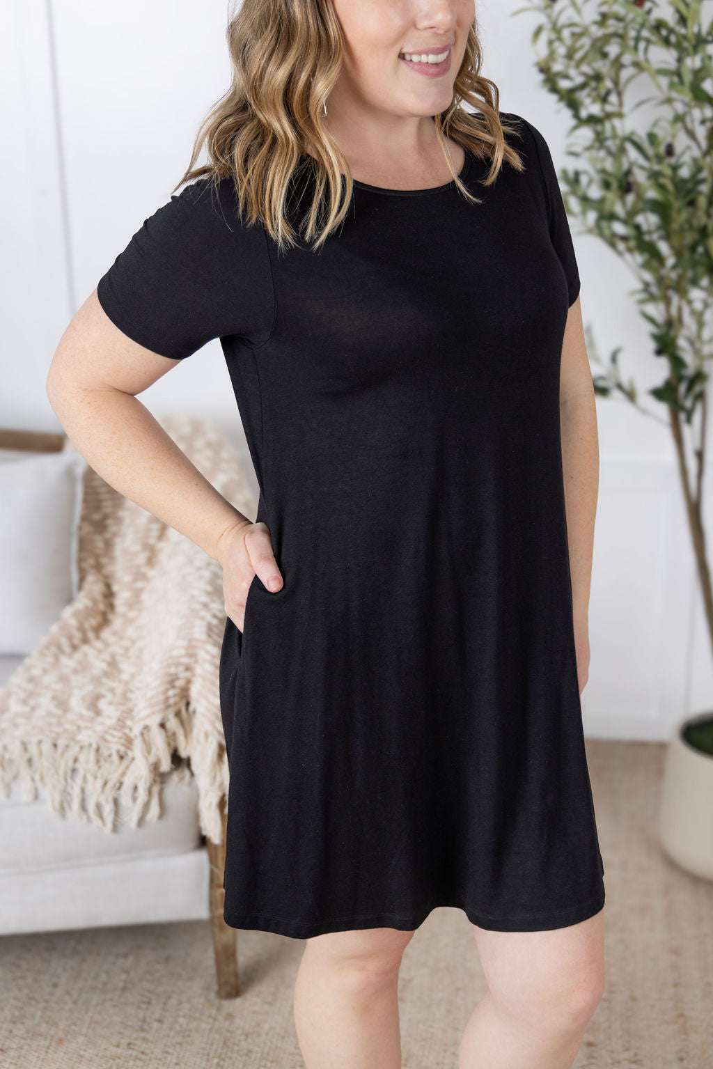 Model wearing the Roxy Swing Tunic Dress in a relaxed swing silhouette with short sleeves and side pockets