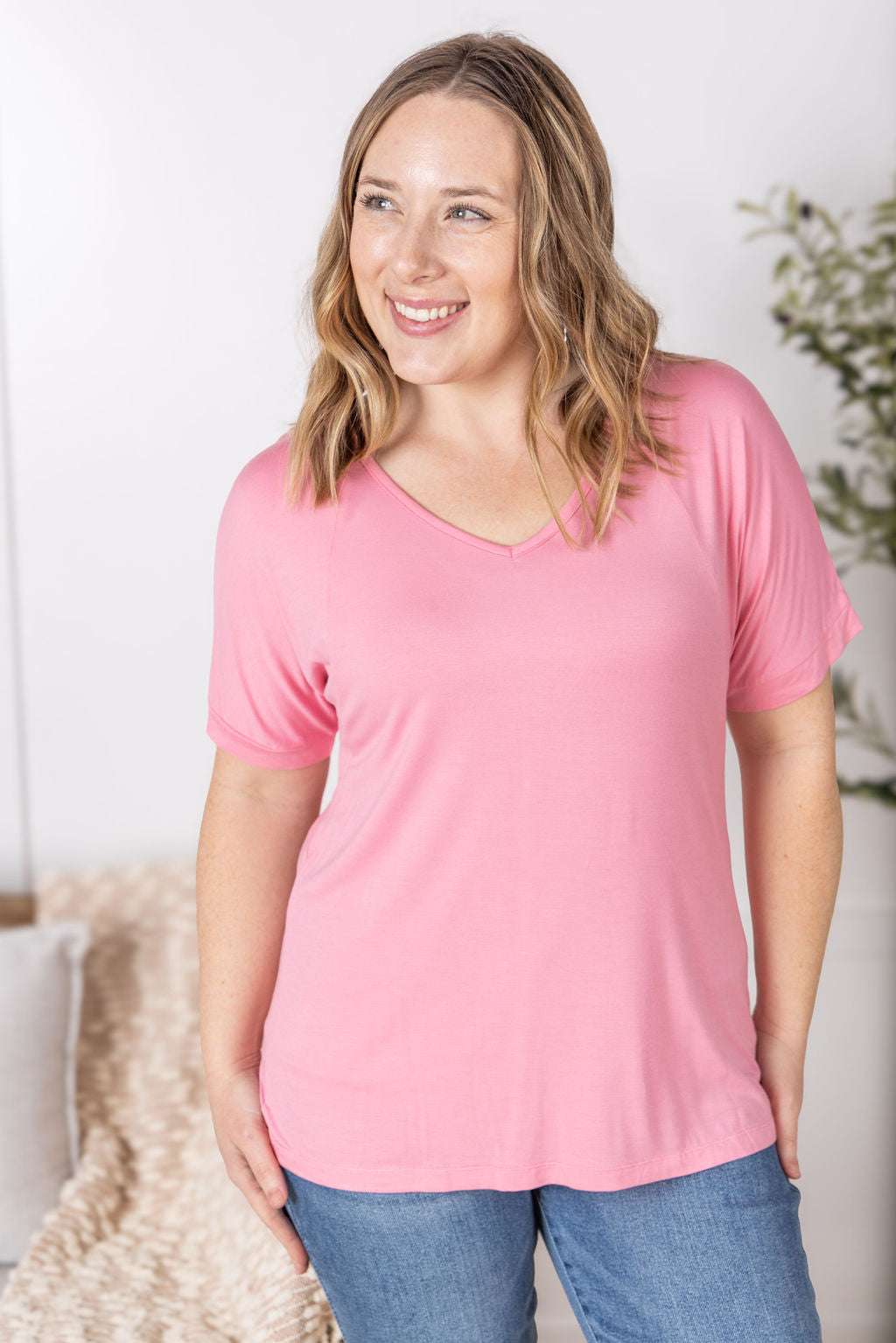 Close-up of a smiling model wearing the Bamboo V Neck Tee in rose by Michelle Mae, featuring a flattering v-neckline, short sleeves, and comfortable relaxed fit
