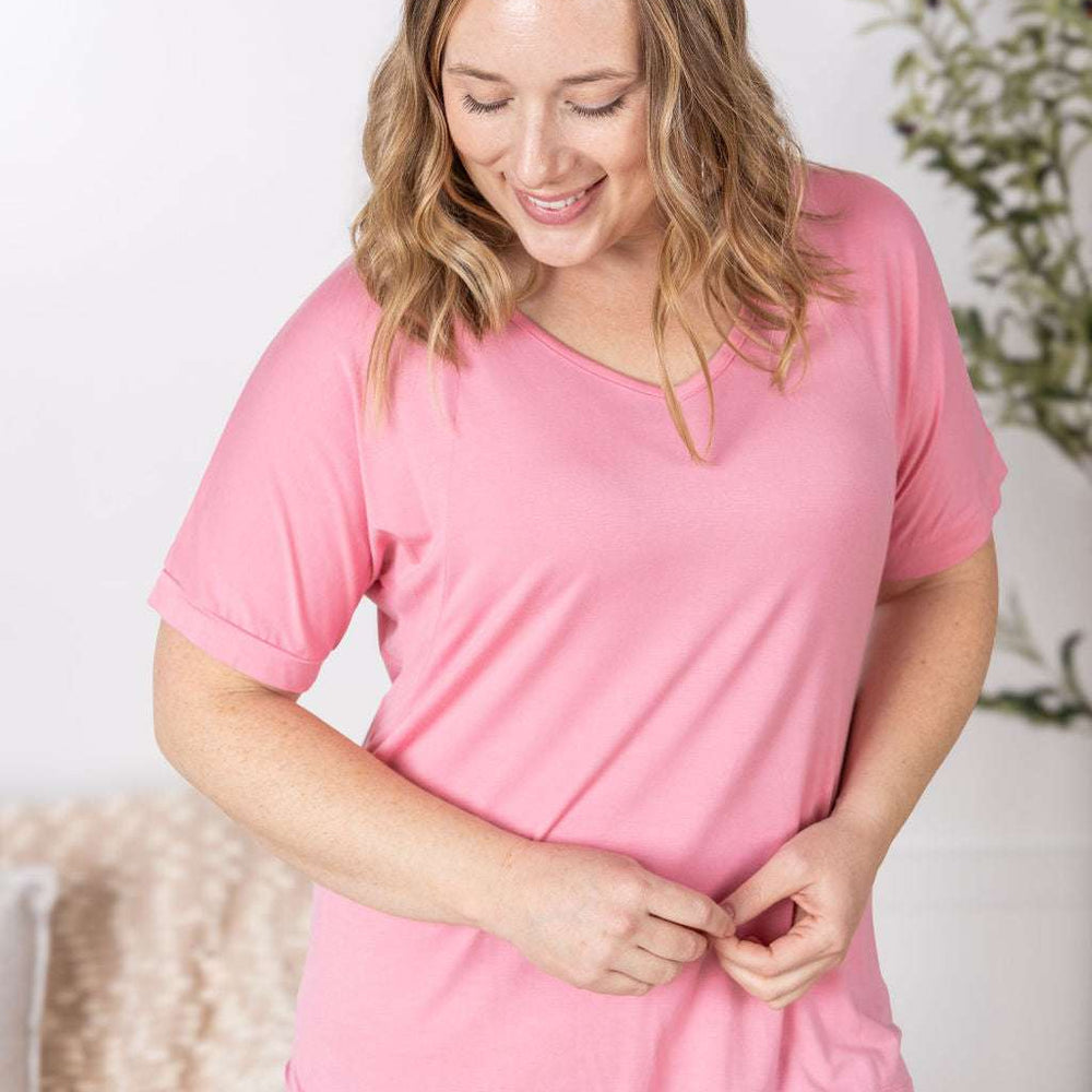 
                  
                    Close-up of a smiling model wearing the Bamboo V Neck Tee in rose by Michelle Mae, featuring a flattering v-neckline, short sleeves, and comfortable relaxed fit
                  
                