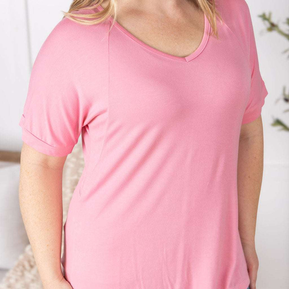 
                  
                    Close-up of a smiling model wearing the Bamboo V Neck Tee in rose by Michelle Mae, featuring a flattering v-neckline, short sleeves, and comfortable relaxed fit
                  
                