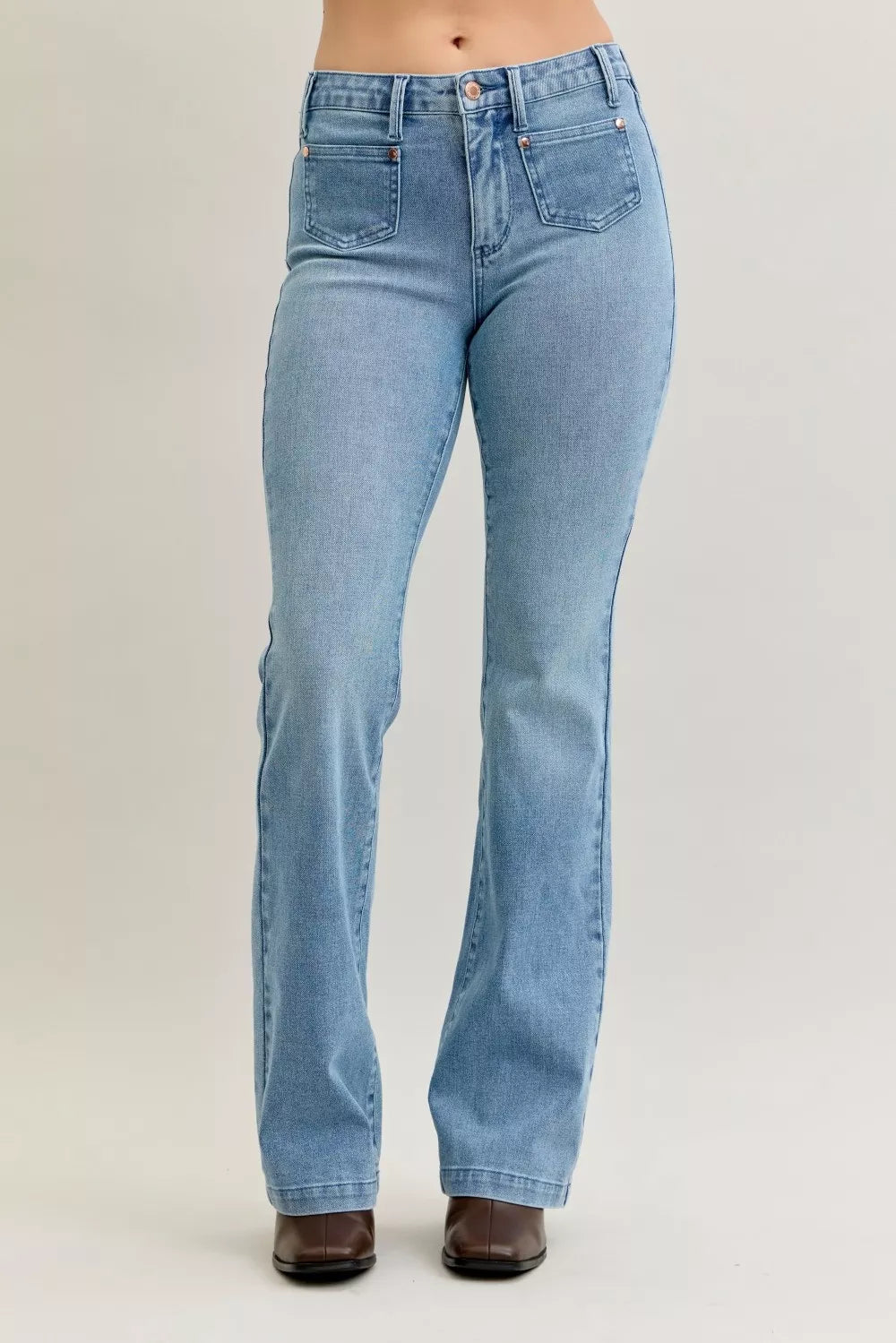 Woman wearing Marlow contrast wash bootcut jeans with distinctive front patch pockets and mid-rise fit