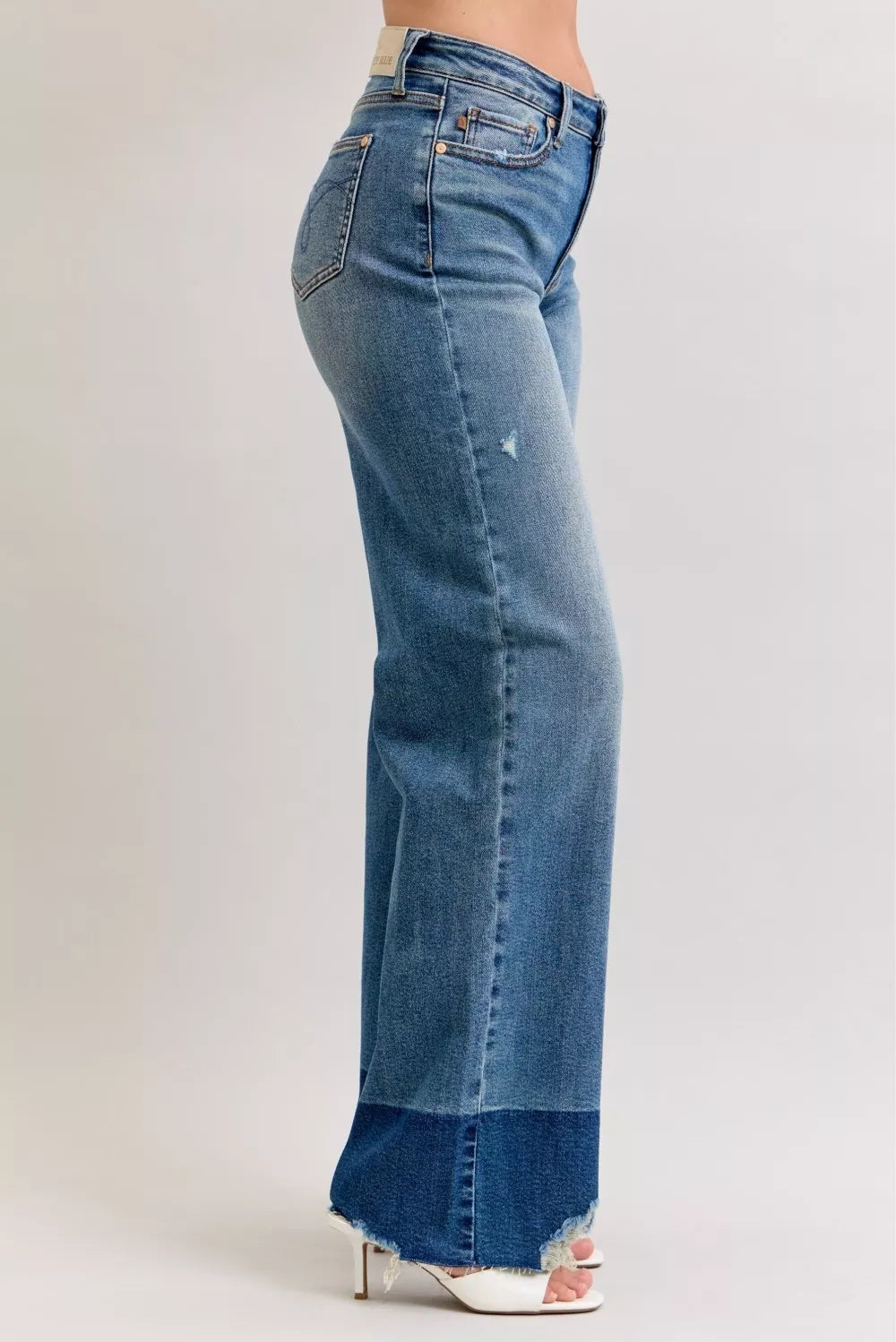 Woman wearing Bristol two-tone high waisted wide leg jeans with raw hem and light wash finish