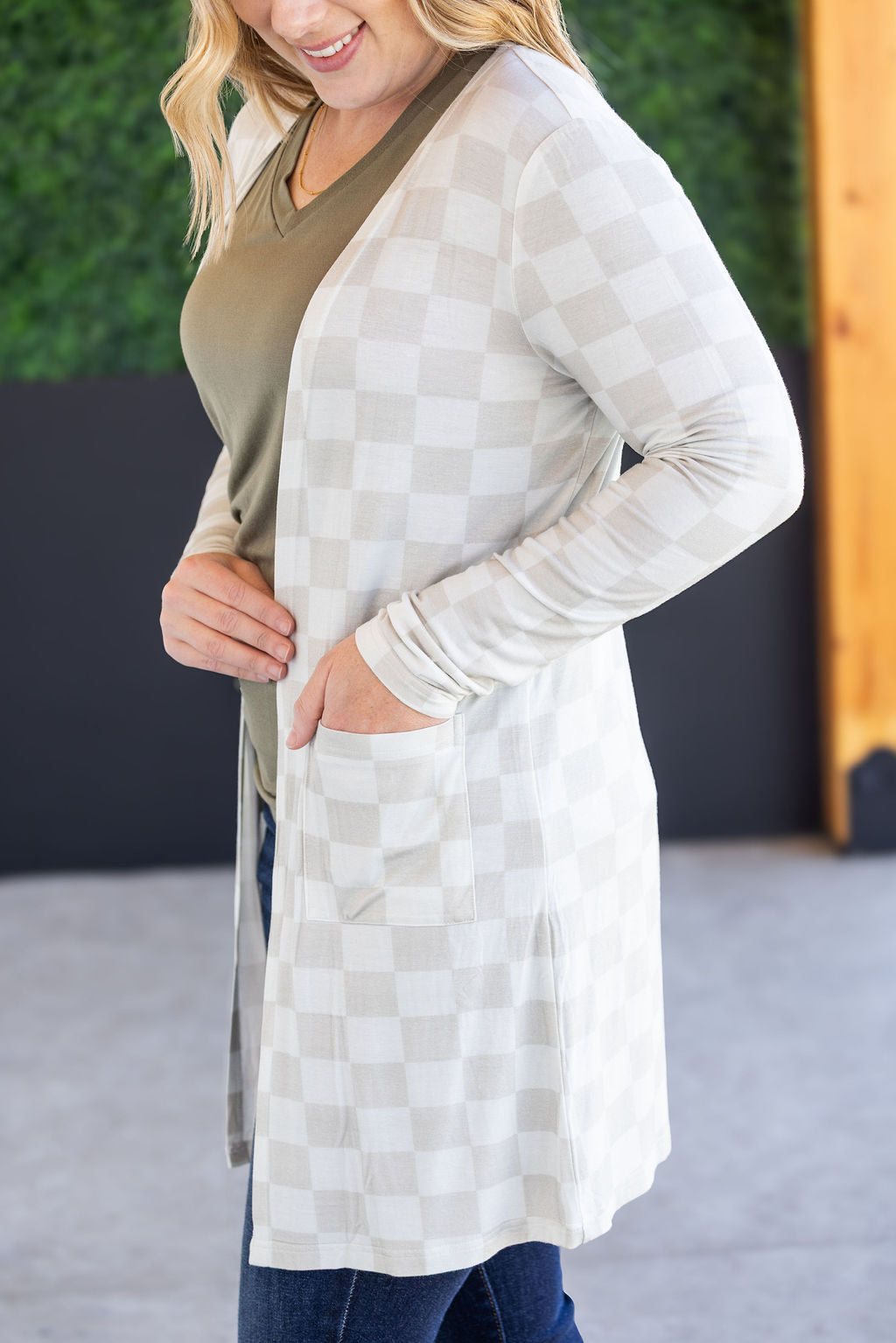 Classic Cardigan in Neutral Checkers with open front and pockets.