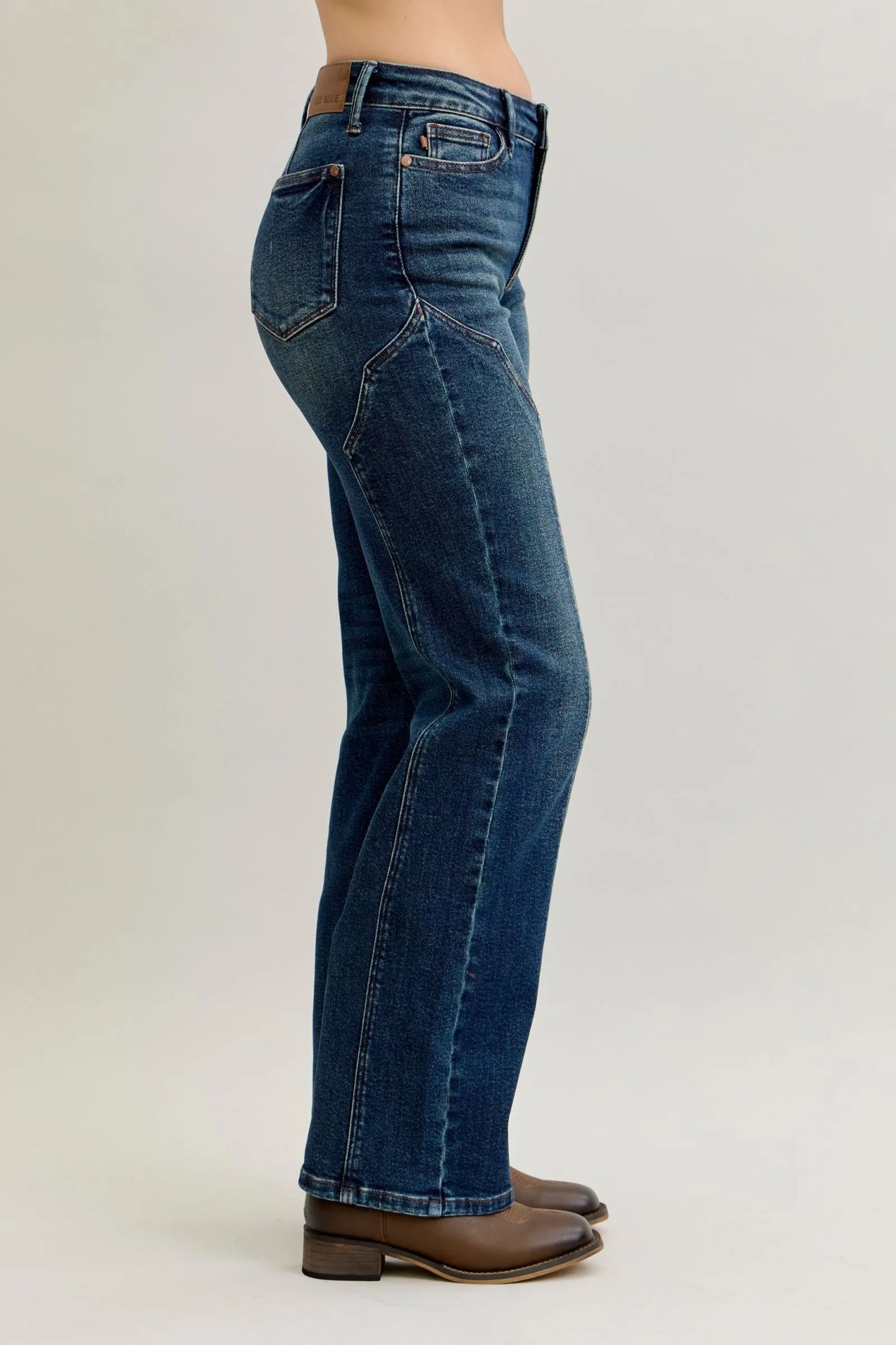 Woman wearing Dawson vintage blue high waisted straight leg jeans with distinctive seamline details down the front