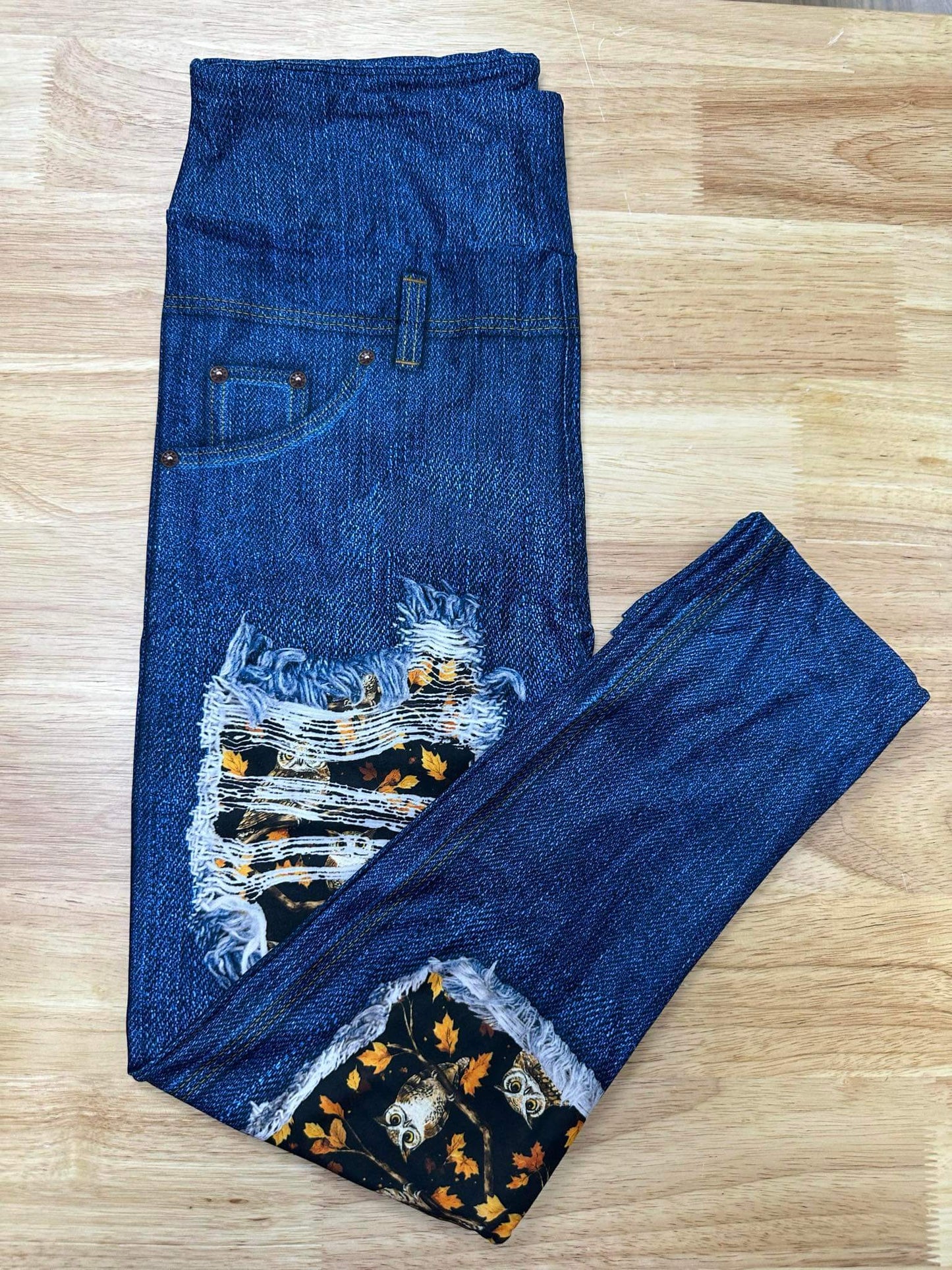 Folded faux denim capri leggings with owl and autumn leaf patchwork detail and distressed-look accents