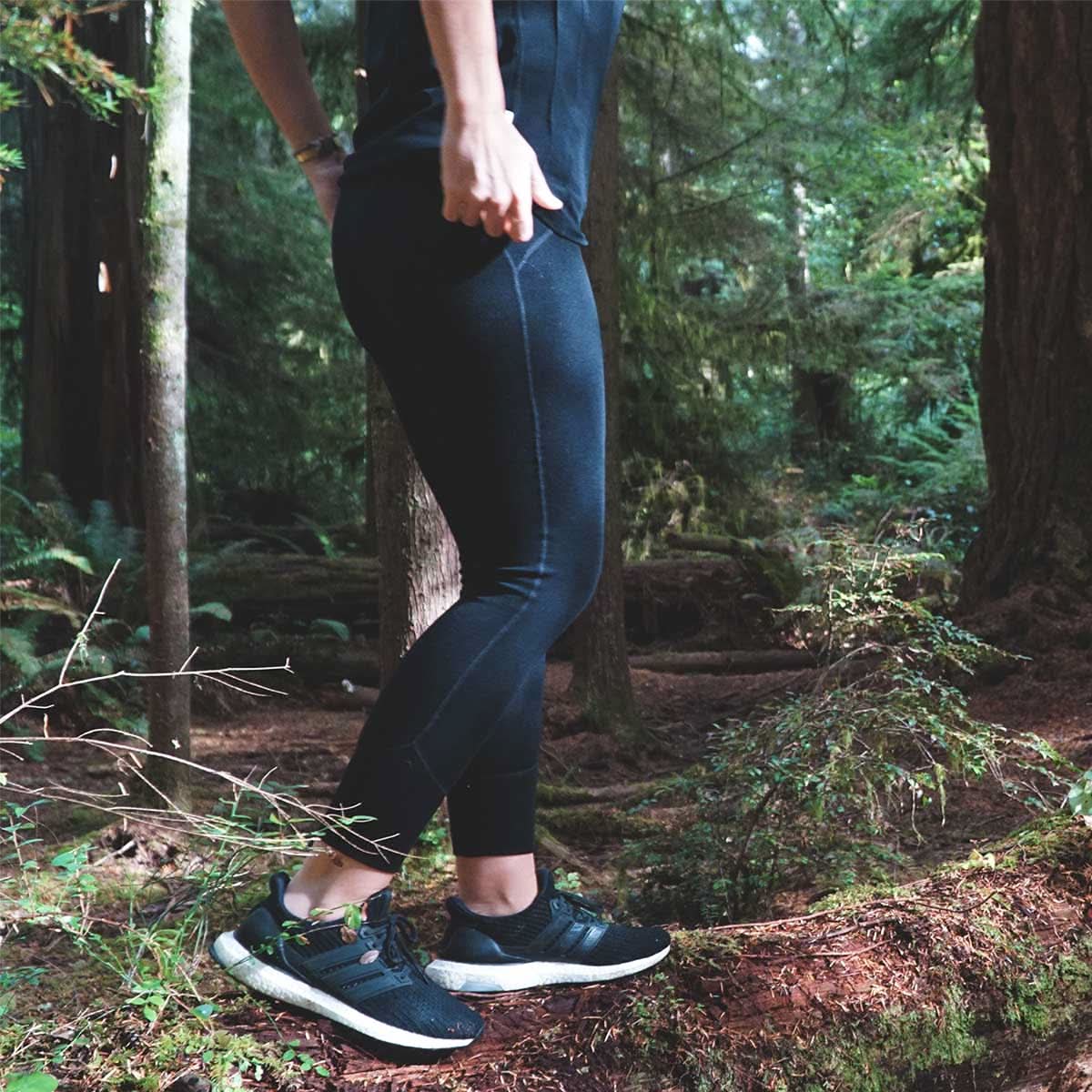 Woman wearing black Woolverino microweight merino wool leggings showing the athletic compression fit and seamless construction