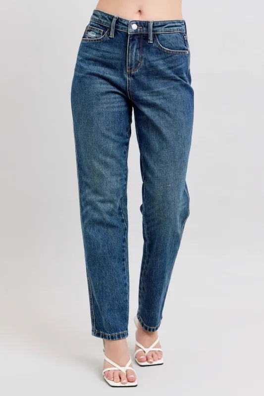 Woman wearing Margo medium wash high waisted rigid straight leg jeans with cropped ankle length