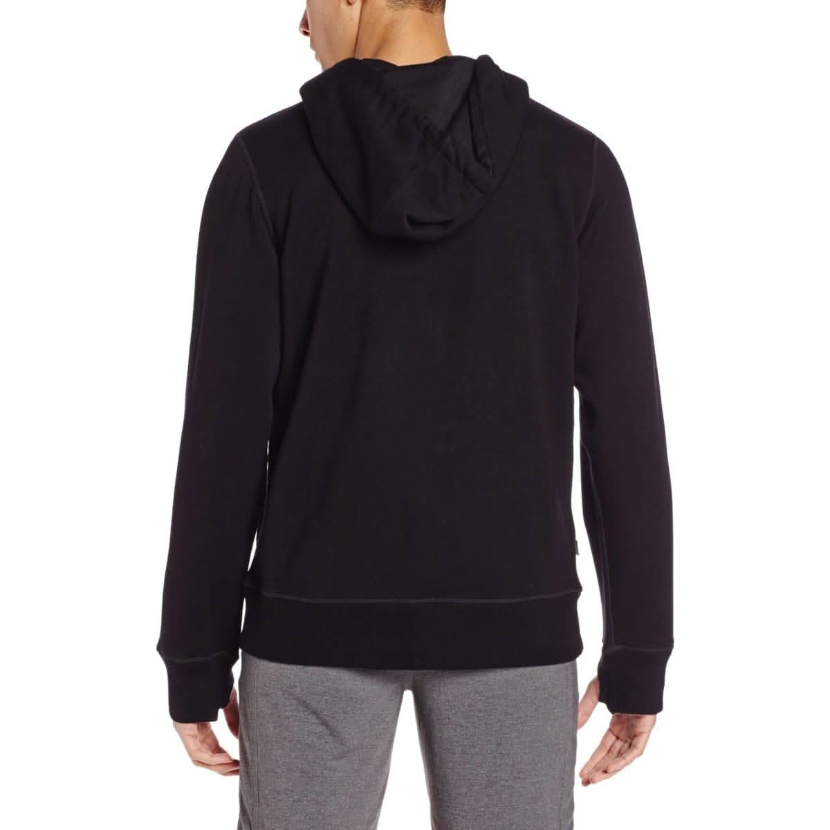Man wearing black heavyweight merino wool hoodie with drawstring hood and thumbholes