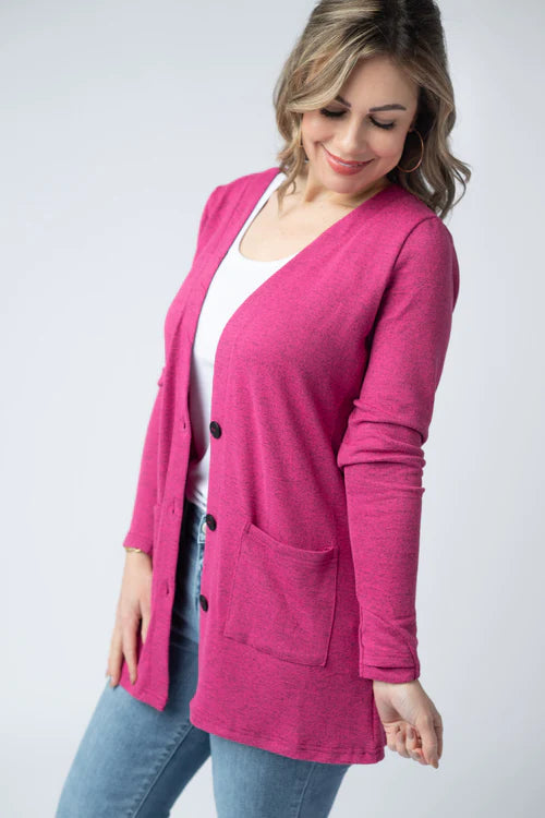 Woman wearing a hot pink Cori Cardigan with button front and pockets, layered over a white tank and jeans