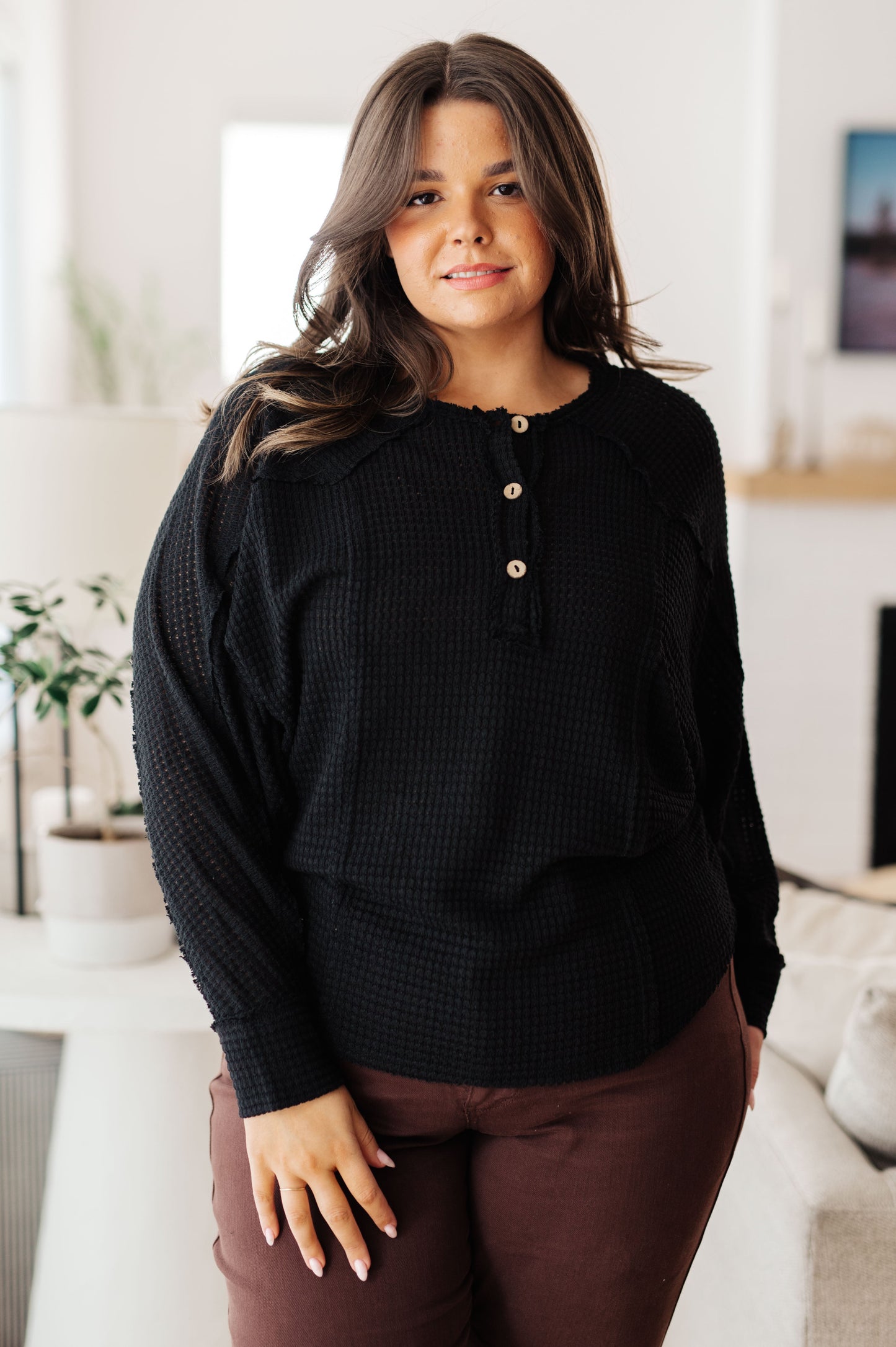 Model wearing the Better than Best Henley Top in black waffle knit with wooden buttons