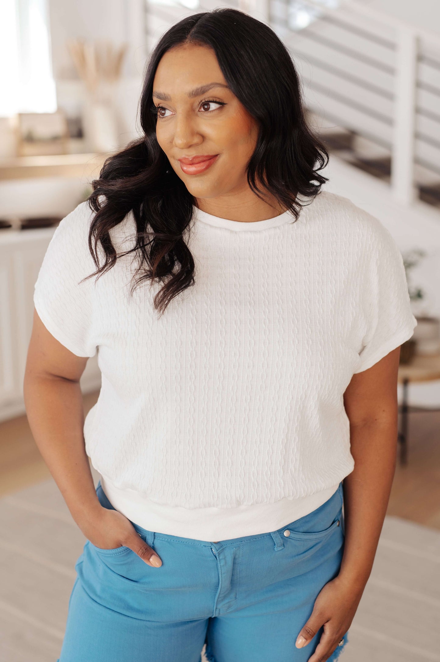 Model wearing white cable knit short sleeve top with ribbed hem and sky blue shorts