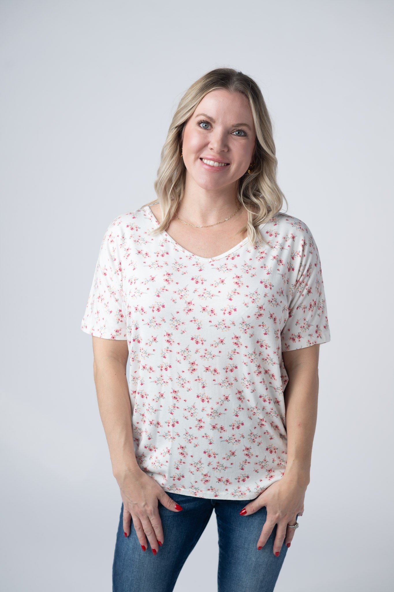 Woman wearing white short sleeve v-neck tee with small pink floral print
