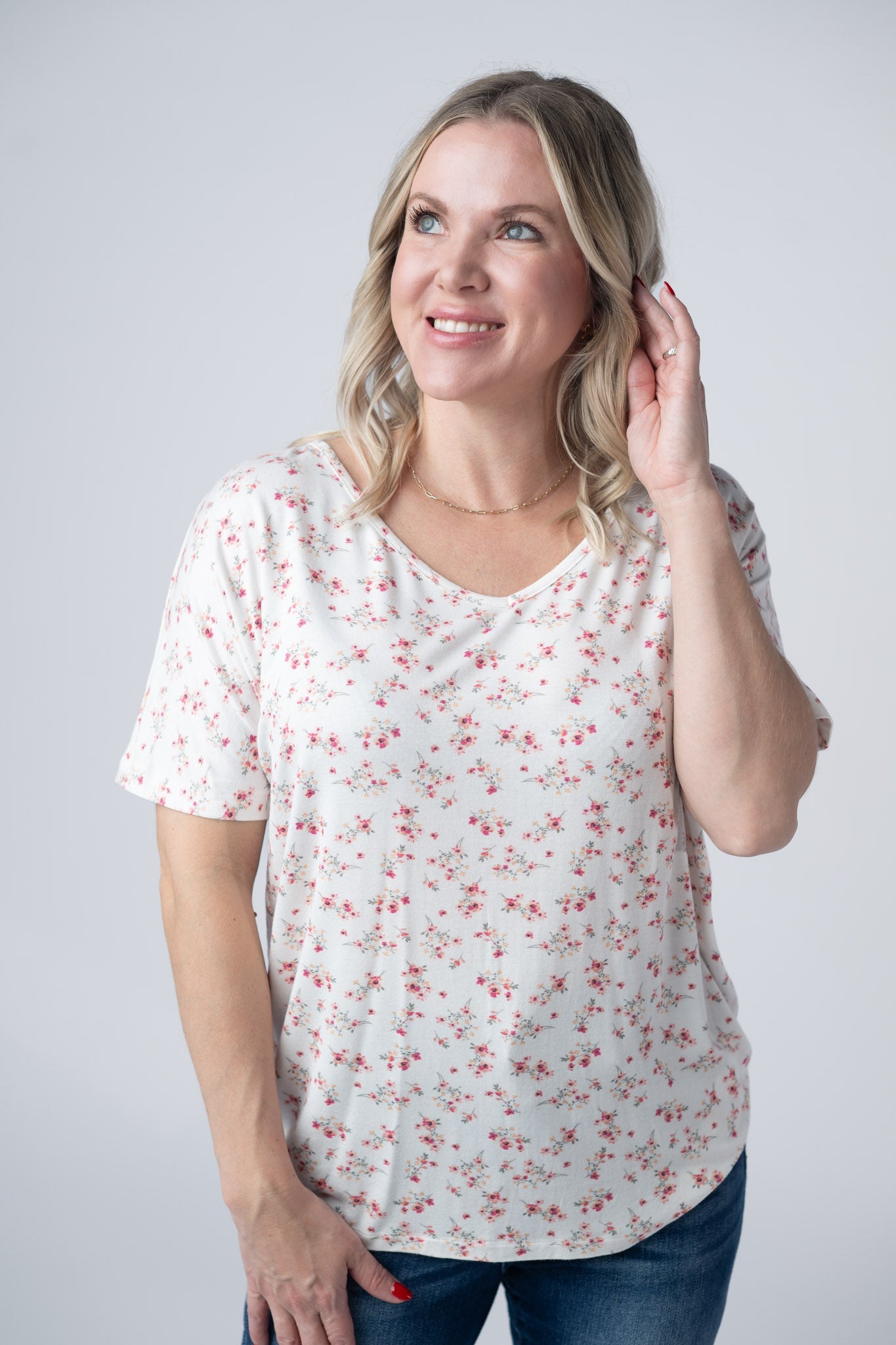 Woman wearing white short sleeve v-neck tee with small pink floral print