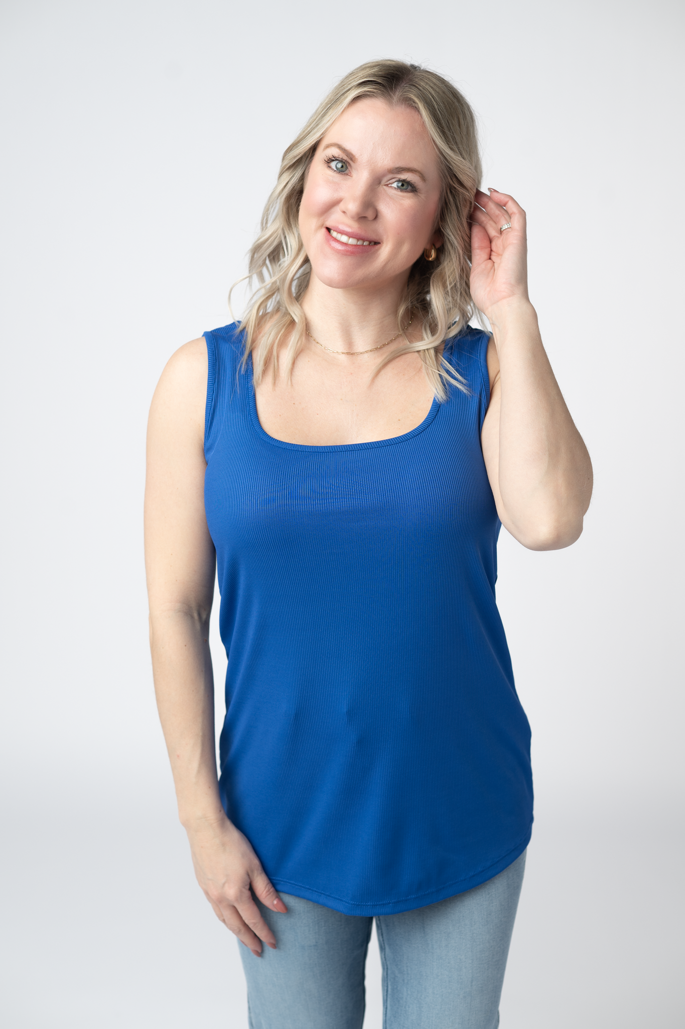 Woman wearing a royal blue Rachel Ribbed Tank with scoop neck and curved hem in lightweight ribbed fabric